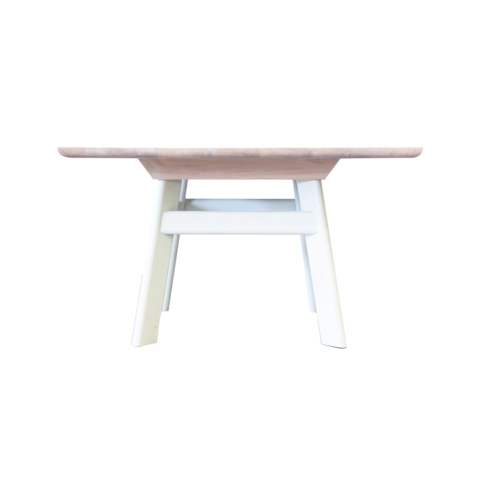 The YOGI Table by One For Hundred showcases a light wood rectangular top made from solid wood and sleek white A-frame legs, all elegantly set against a plain white background.