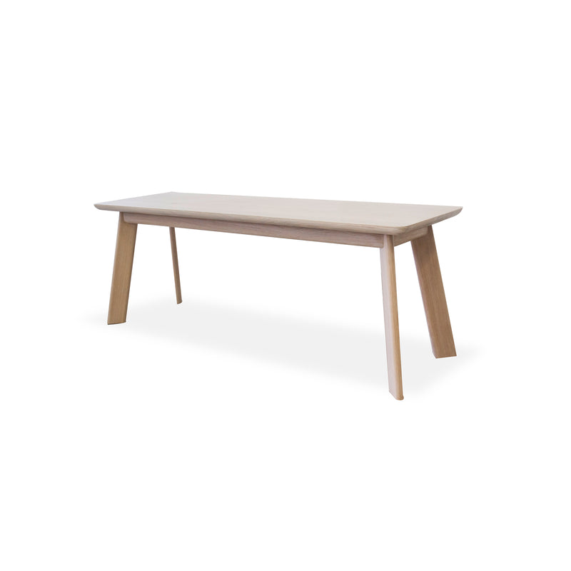 From the YOGI collection by One For Hundred, this customizable, minimalist wooden bench features a light finish with a flat rectangular seat and four gently angled legs against a white background, crafted from solid wood for lasting elegance and versatility in any setting.