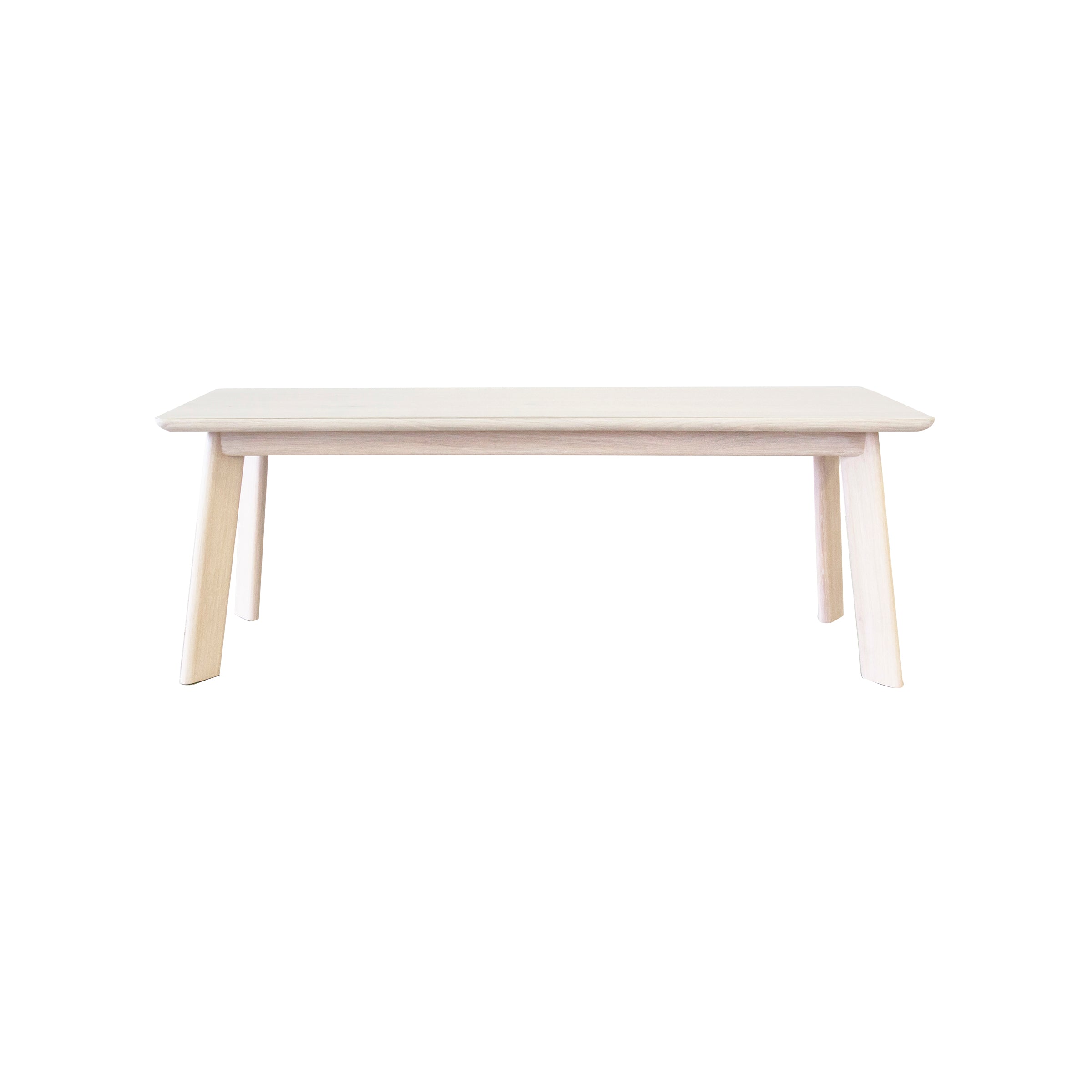 The YOGI Bench by One For Hundred is a minimalist piece with a light finish, featuring a rectangular top and four slightly angled legs. This solid wood furniture item exudes elegance against a plain white background.