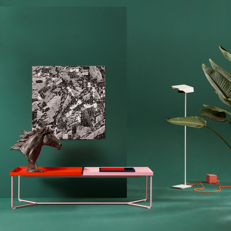 A modern interior showcases a green wall, black-and-white art, and a red/pink console. A horse head sculpture sits beside a white floor lamp on the Victor Foxtrot POI DOUBLE Coffee Table with sleek steel frame accents and leather inlays.
