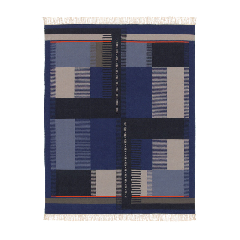 The RH02 Kilim Zet by E15 is a rectangular textile art piece crafted from hand-spun sheep wool, showcasing geometric patterns in blue, black, and beige. It features bold vertical and horizontal lines, rectangles, and fringed edges inspired by Richard Herre designs.