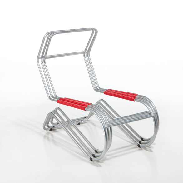 The Lido Lounger by WB Form is a modern tubular steel chair featuring minimalist geometric shapes with red accents on the seat and backrest. Its unique design includes multiple bent metal tubes forming the frame and legs, combining style with innovation.