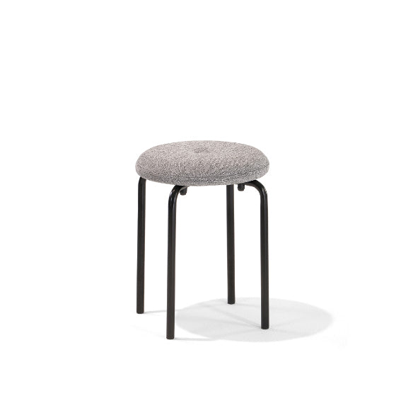 The Tom Stackable Stool by Richard Lampert boasts a round, textured gray cushion and four black metal legs. Its sleek design and stackable function make it charming and practical, shown against a plain white background.