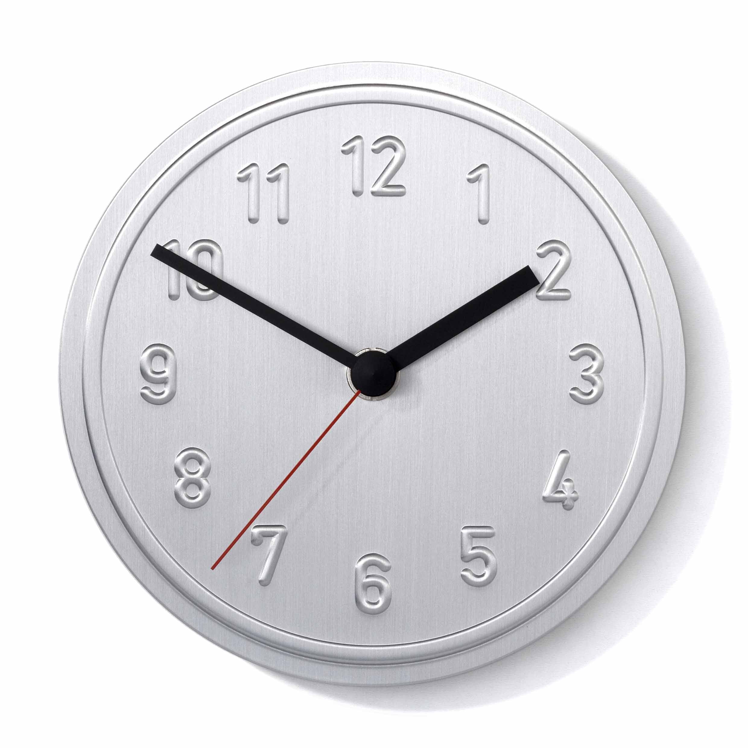The Alu Alu Wallclock by Richard Lampert is a minimalist round silver clock made of aluminum with embossed numbers, black hands, and a thin red second hand set at 10:10. This quartz clock features Jochen Gross sleek metallic design.
