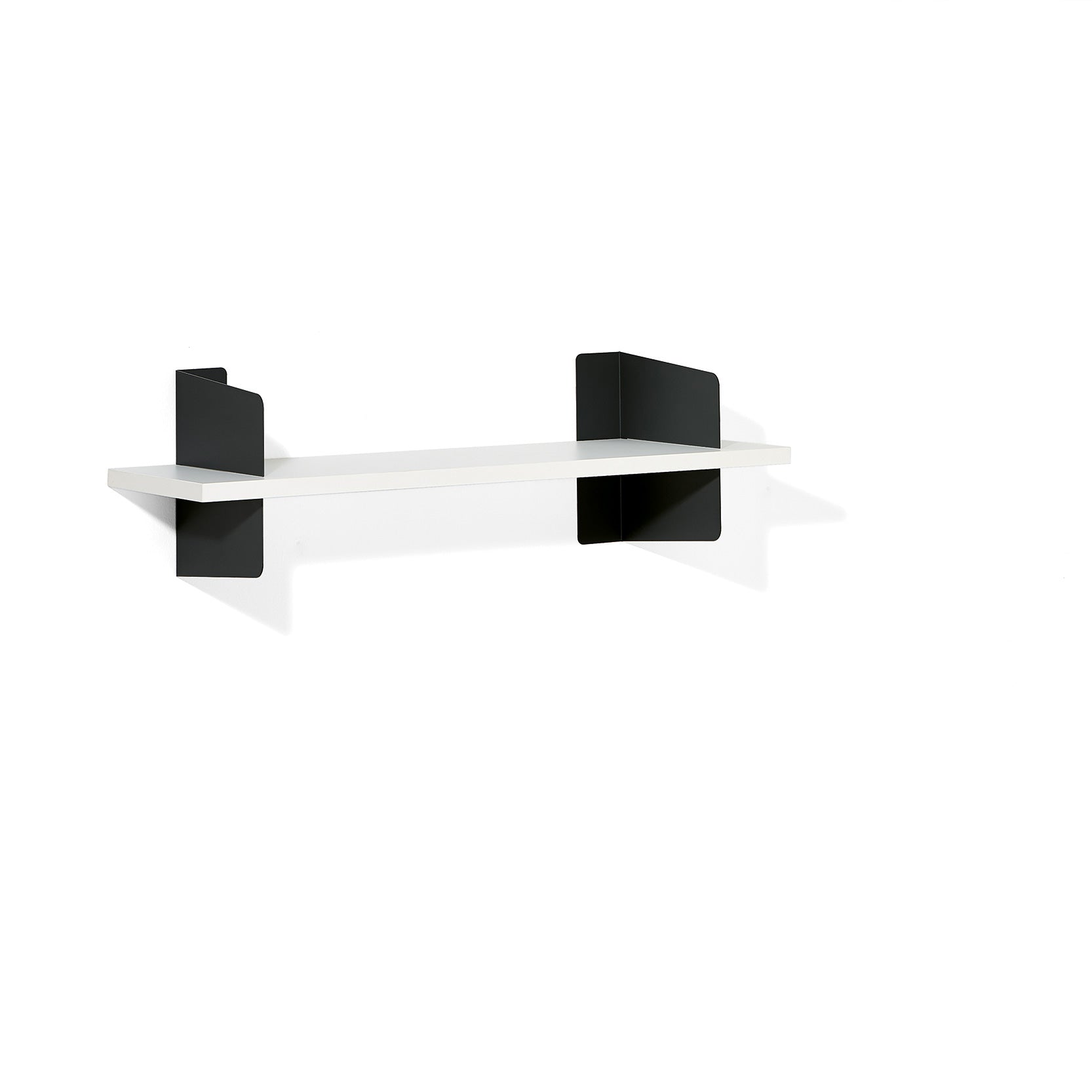 The Atelier by Richard Lampert is a minimalist wall-mounted shelf featuring a white horizontal platform supported by sleek steel brackets. Its simple, contemporary design stands out elegantly against a plain white background.