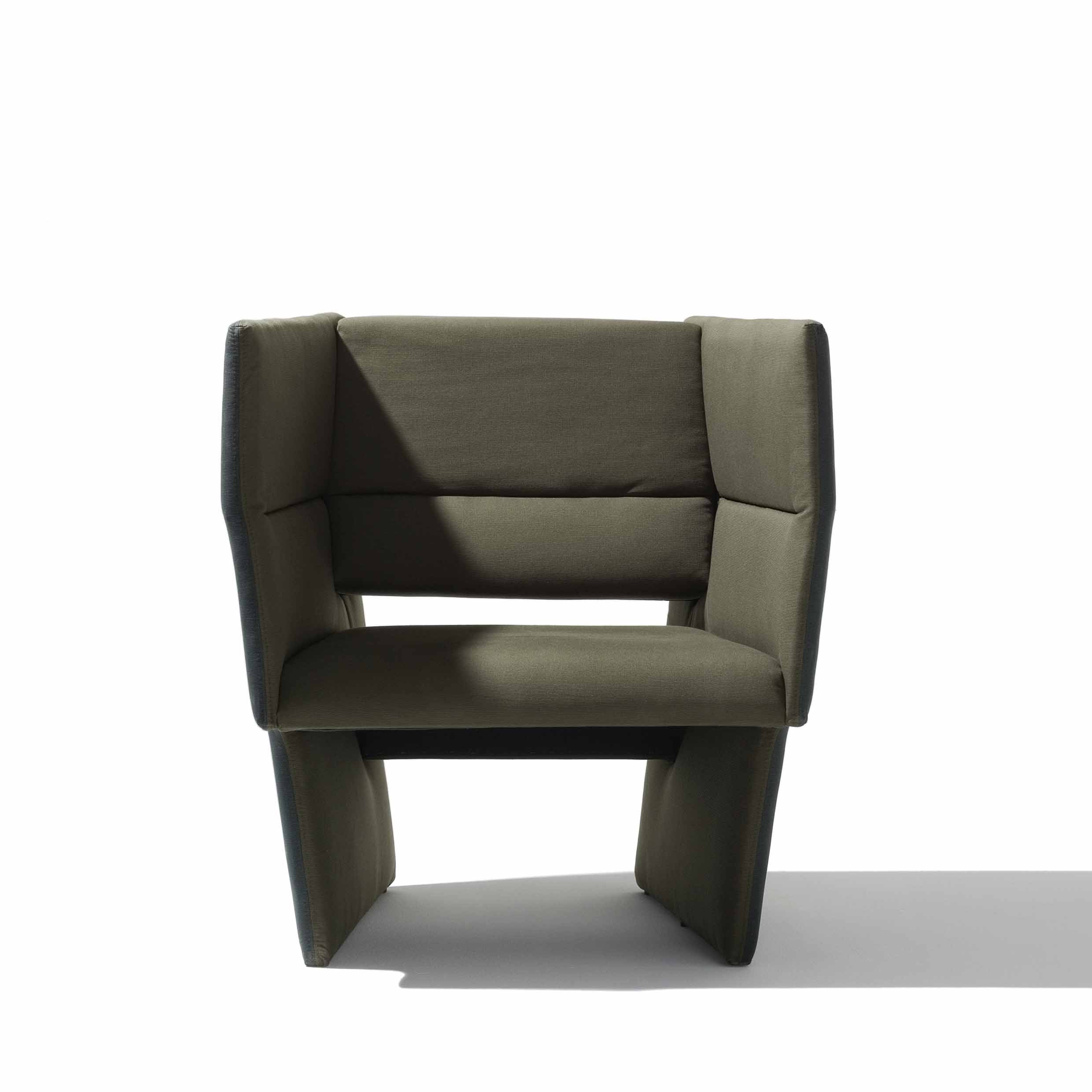 The Richard Lampert Cup Lounge Chair is a modern, olive green armchair with a boxy, avant-garde design, featuring high-end upholstery and a solid wood frame. Its set against a plain white background with a soft shadow on the surface.