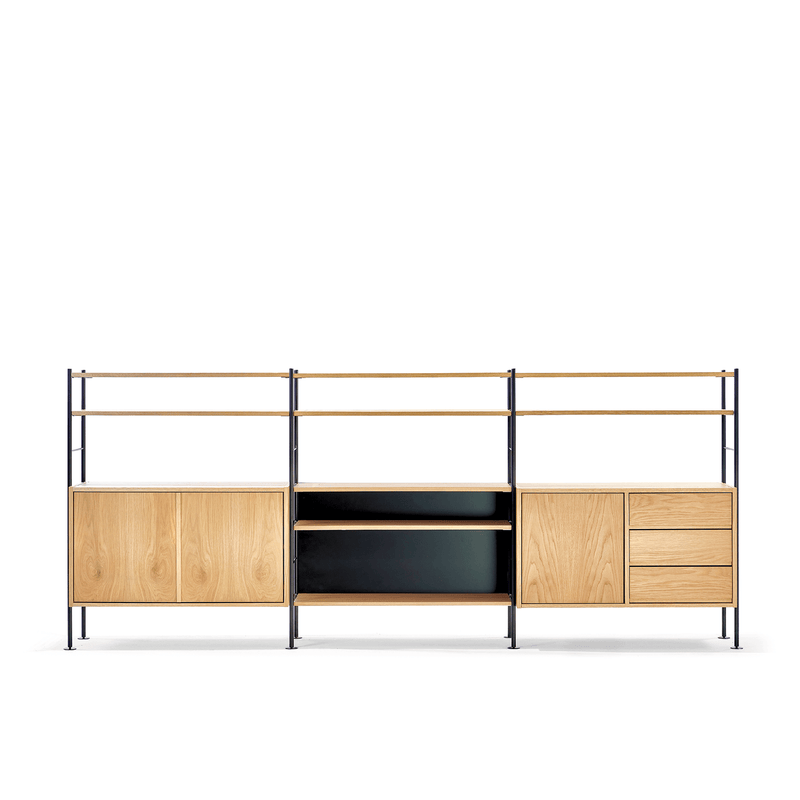 The DHS10 Shelf by Richard Lampert exemplifies German industrial design. The left unit includes a double-door cabinet and open shelves, while the right features three drawers. Central black shelves enhance the minimalist and functional aesthetic of this versatile modular system.