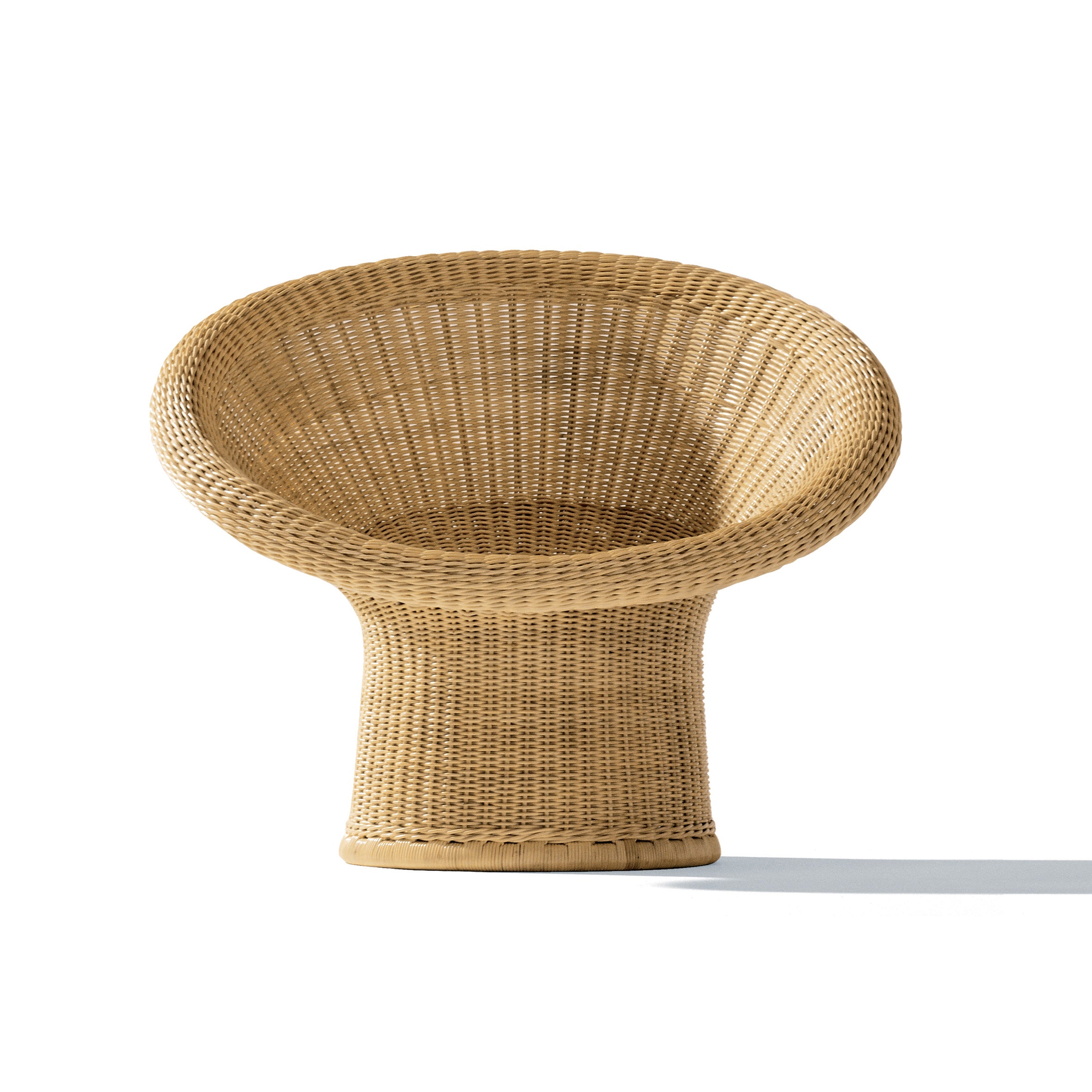 The E10 Lounge Chair by Richard Lampert features a rounded back and flared base, casting an elegant shadow on the white background, reminiscent of Egon Eiermanns rattan furniture designs.