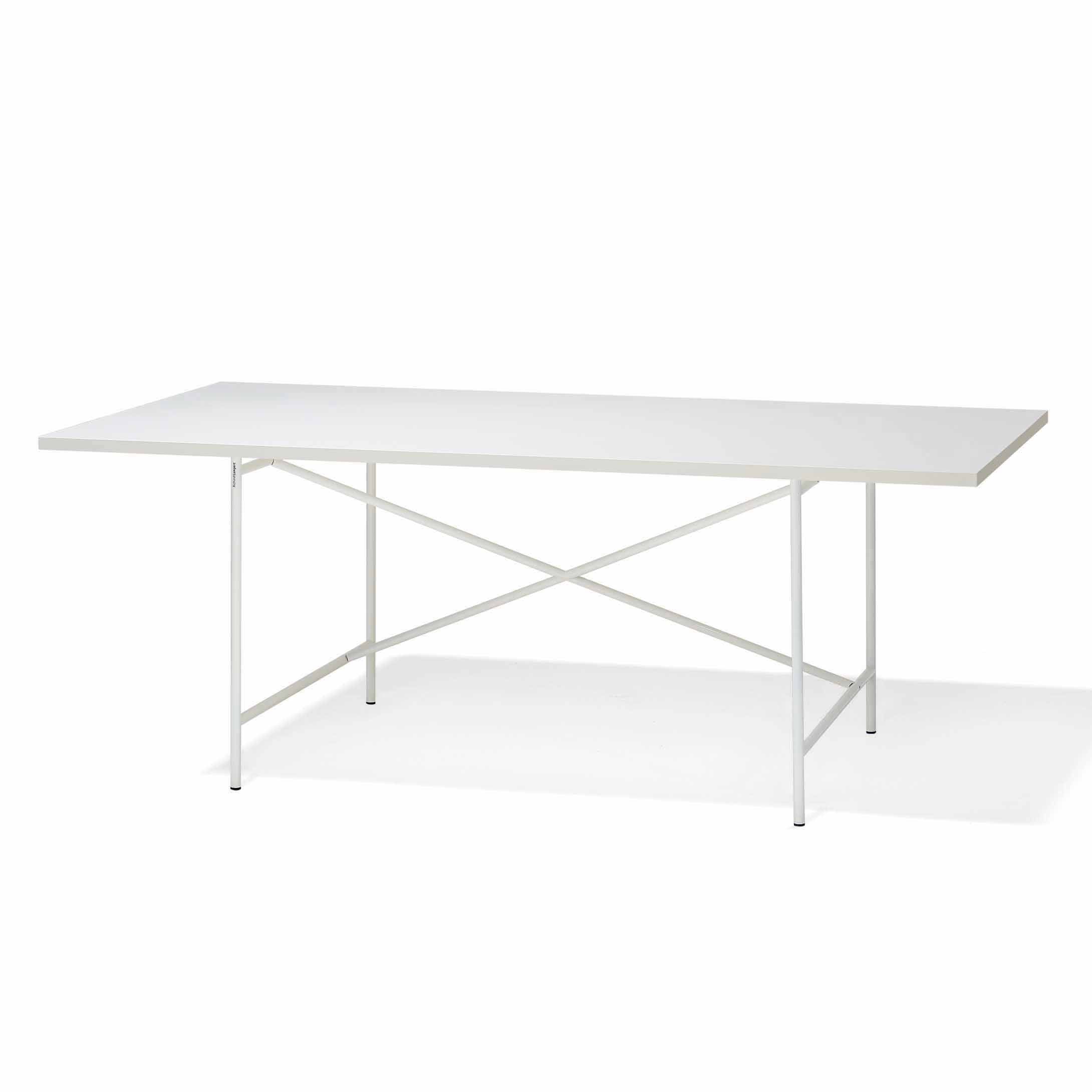 The Eiermann 1 Table by Richard Lampert is a minimalist white rectangular table, featuring slender legs and a cross-braced support, echoing the classic design. Its simple, modern aesthetic suits various settings, embodying Lamperts timeless furniture design approach.