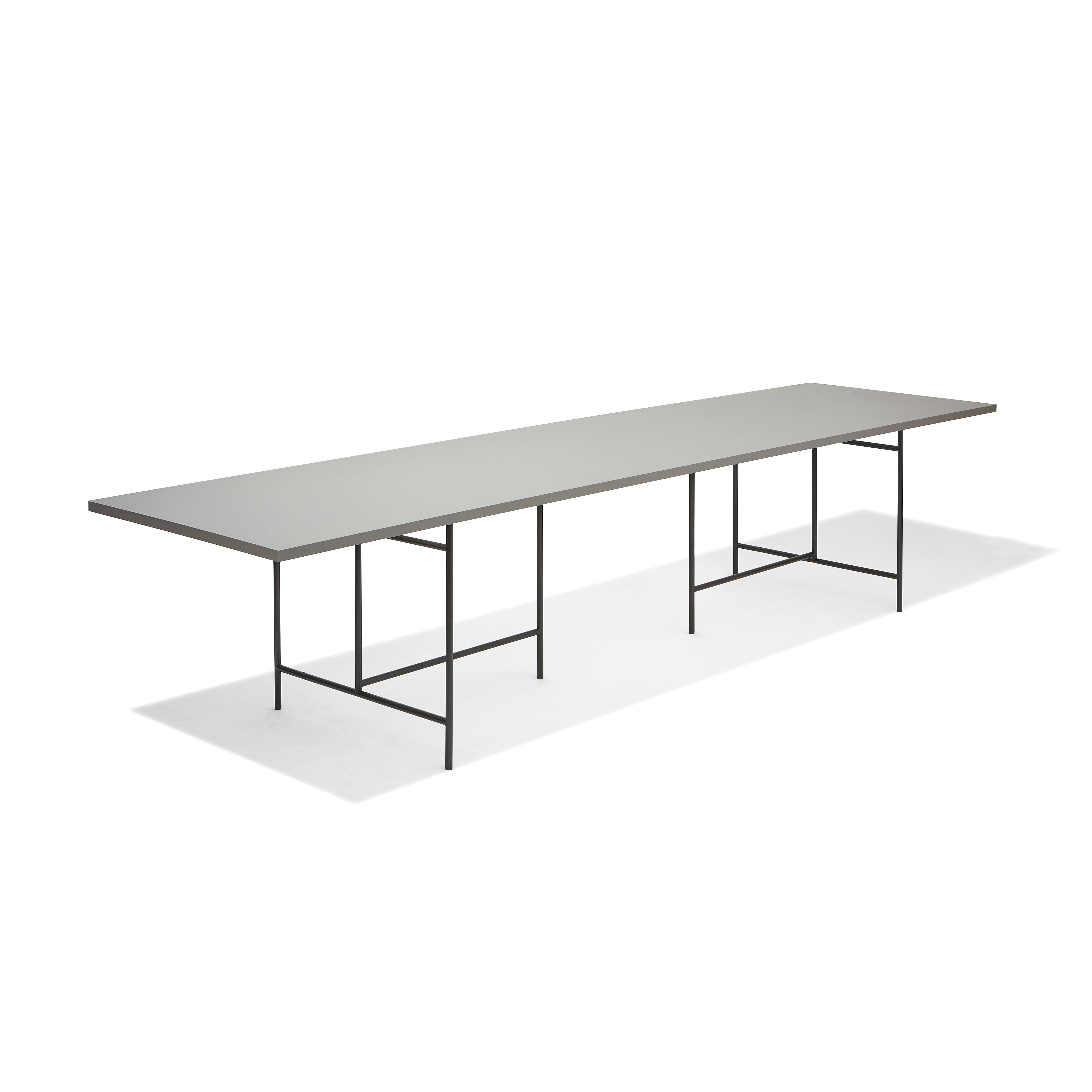 The Eiermann 3 Table by Richard Lampert features a modern, minimalist style with a thin, light gray surface and slender black metal legs, ideal for worktops or conference tables.