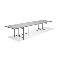 The Eiermann 3 Table by Richard Lampert features a modern, minimalist style with a thin, light gray surface and slender black metal legs, ideal for worktops or conference tables.