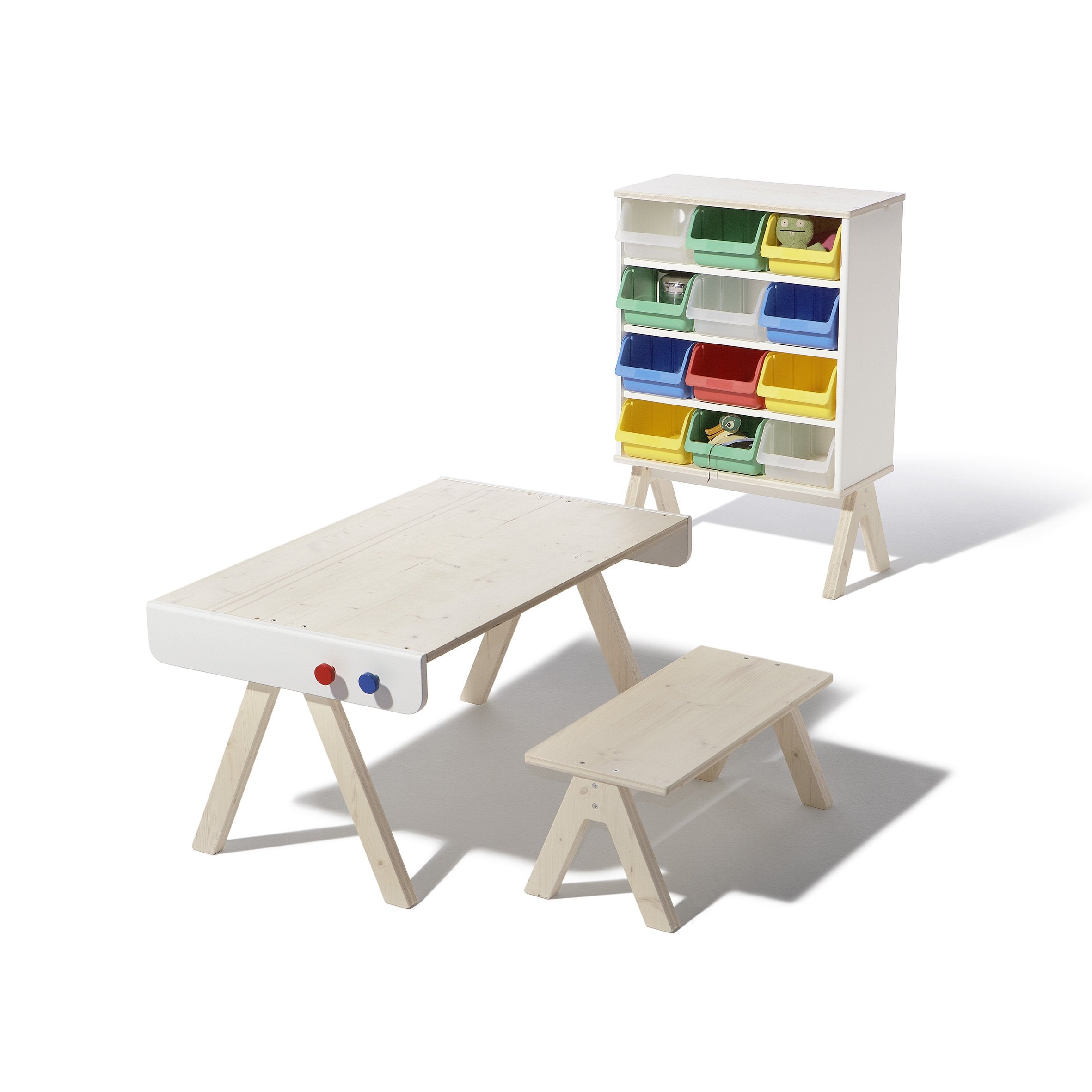 The Famille Garage - Storage by Richard Lampert is a childrens wooden furniture set, including a minimalist table, bench, and a versatile storage unit with colorful bins in green, blue, yellow, and red for easy organization. Its perfect for adding style to any room.
