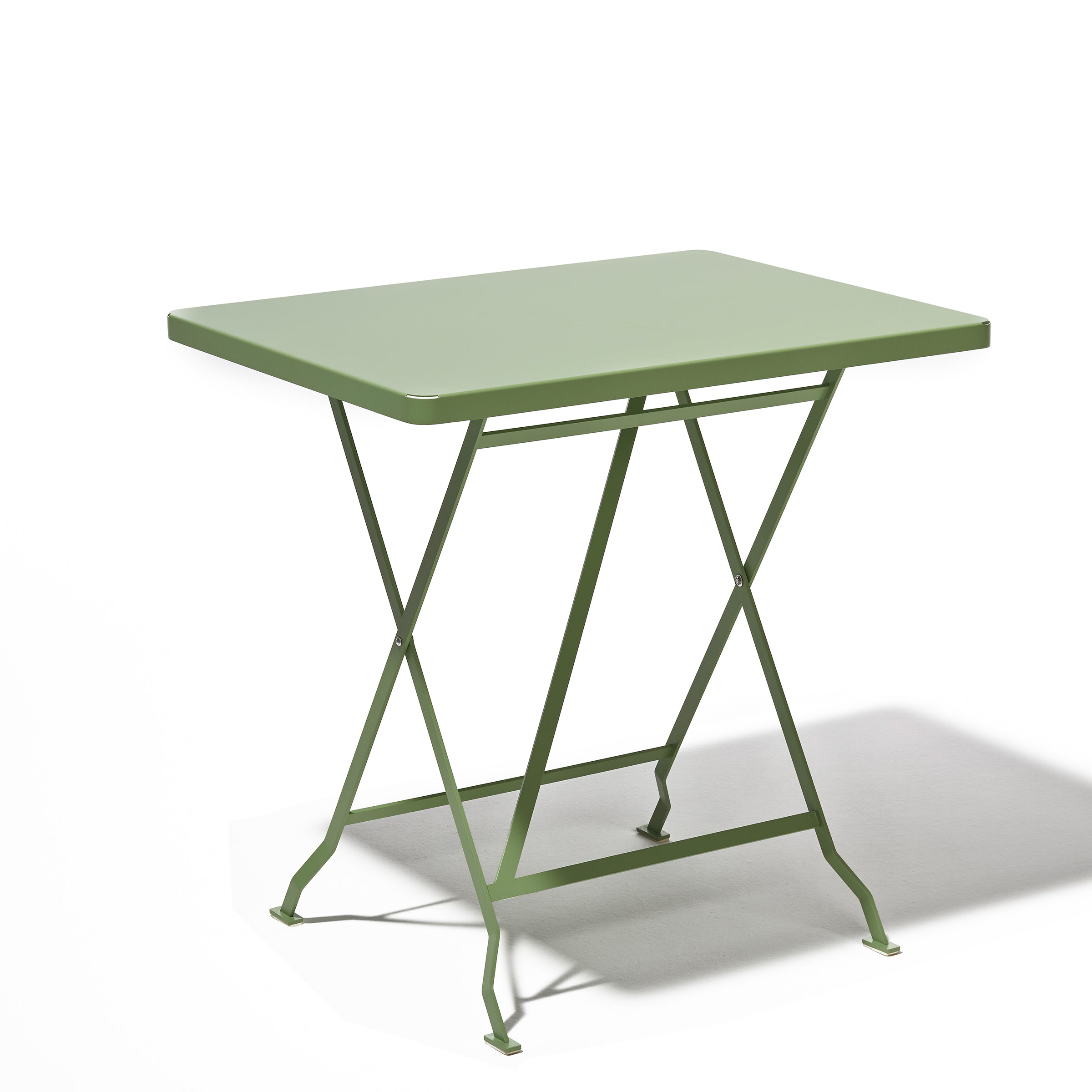 The Flip Bistro Table by Richard Lampert features a minimalist design with crossed legs, crafted from stainless steel in a green square shape, set against a plain white background.