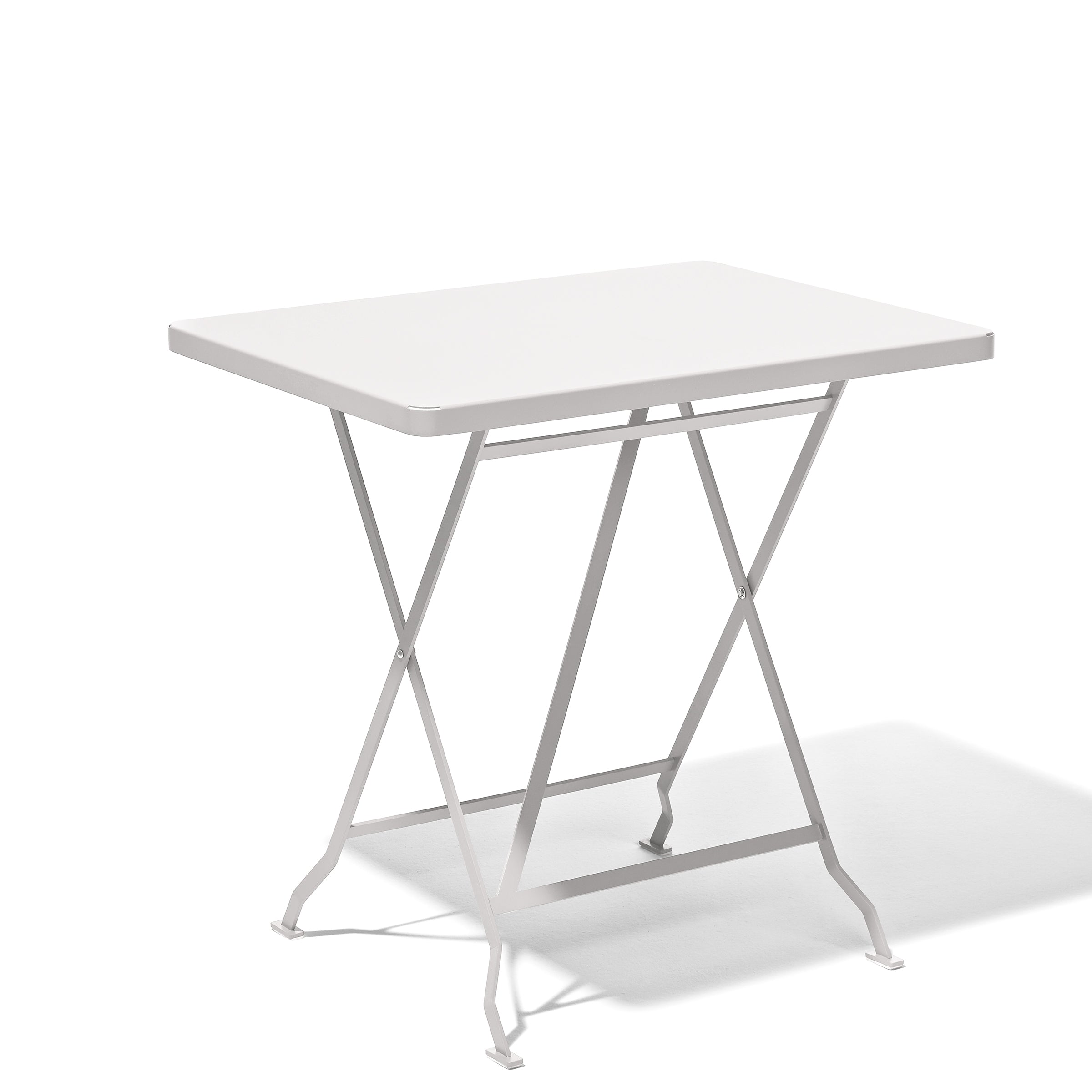 The Flip Bistro Table by Richard Lampert is a sleek white, metal folding table with crossed legs and a thin flat surface. Made of stainless steel, it casts a faint shadow on its white background, ideal for indoor or outdoor dining.