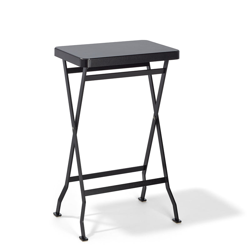 The Flip Side Table by Richard Lampert is a sleek, black folding table featuring a rectangular surface and crossed stainless steel legs, set against a white background.