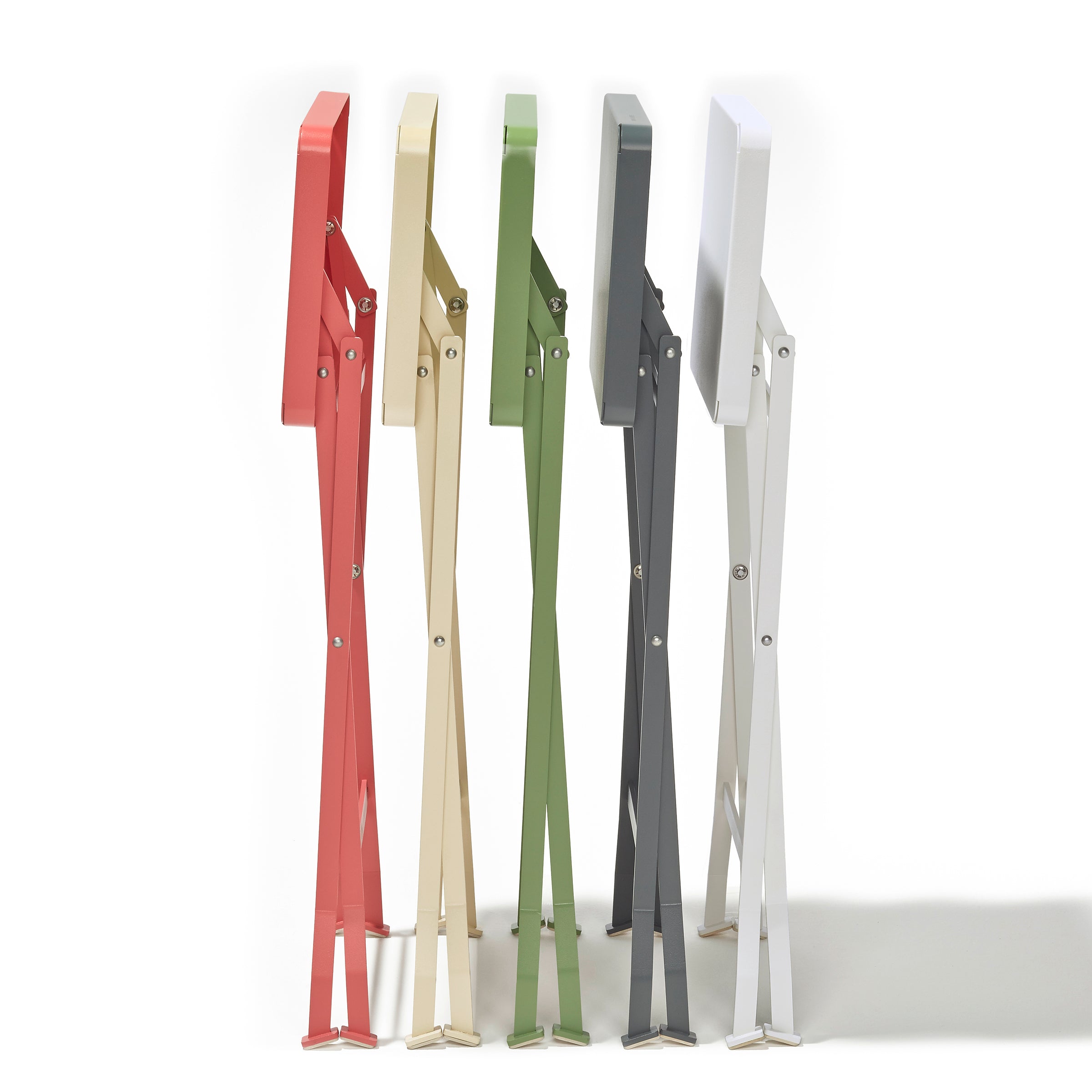 Five modern Flip Side Tables by Richard Lampert, available in red, beige, green, black, and white, stand side by side. Their slim design features two legs and a rectangular top of premium quality, casting subtle shadows on a white surface.