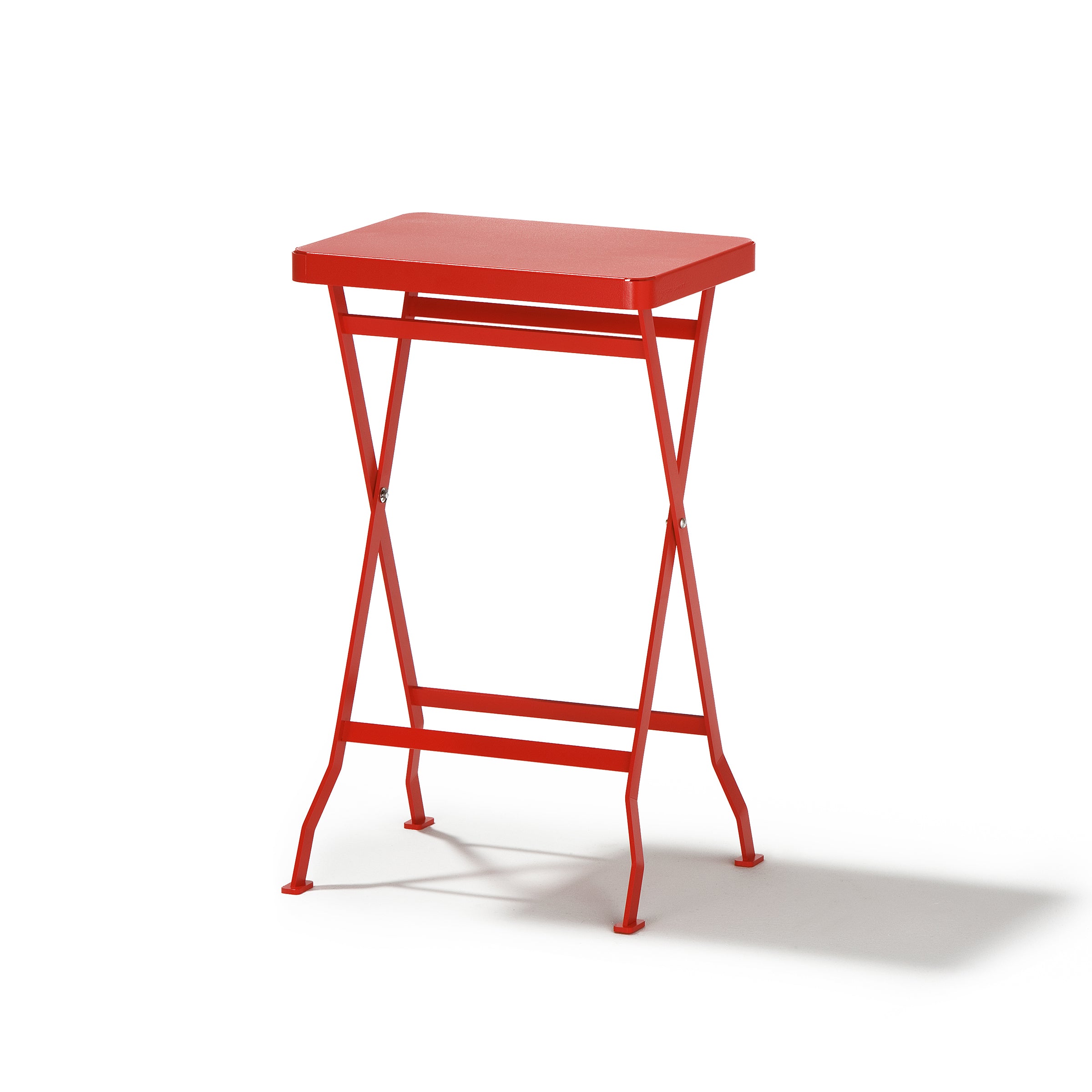 The Flip Side Table by Richard Lampert showcases a premium-quality red rectangular top with X-shaped legs, elegantly presented against a white backdrop.