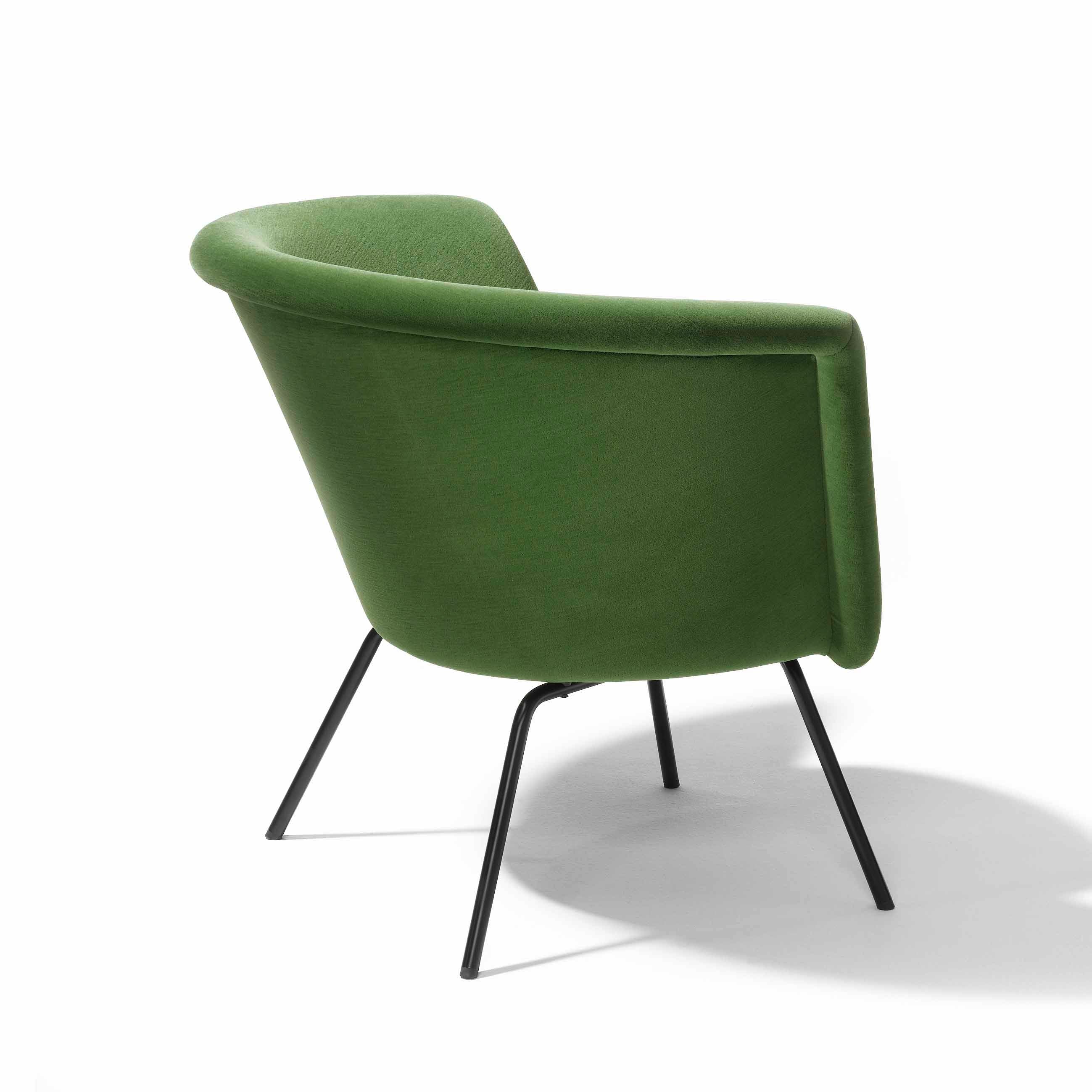 The mid-century design of the H 57 Lounge Chair by Richard Lampert features a green modern look with a rounded backrest and four slender black metal legs angled slightly backward, echoing the elegance of Herbert Hirche furniture against a crisp white background.