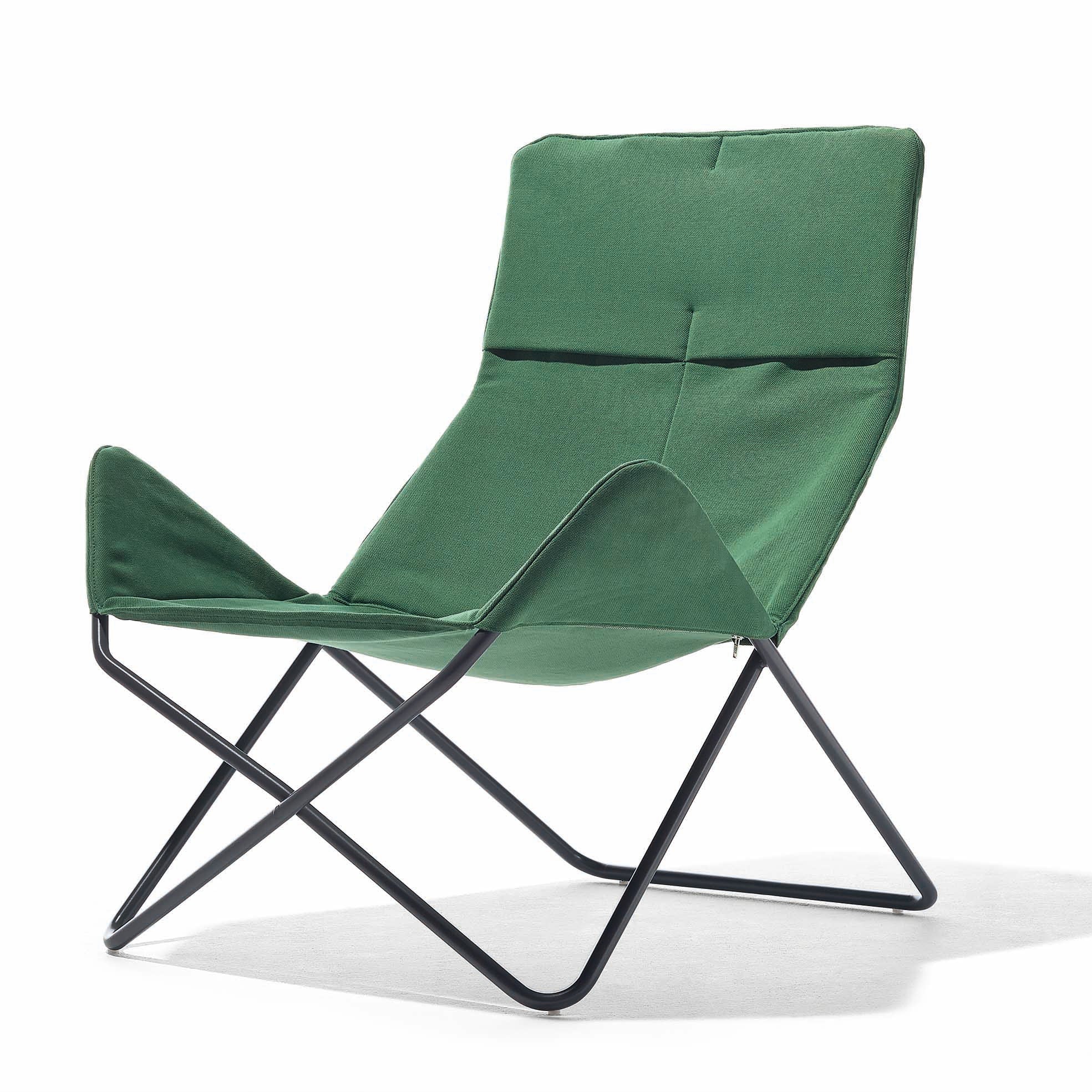 The Richard Lampert In-Out Chair is a modern, lightweight armchair with a green fabric seat and backrest on a sleek black metal X-shaped frame. Ideal for outdoor use, its minimalist design ensures weather-resistant durability and a contemporary look.
