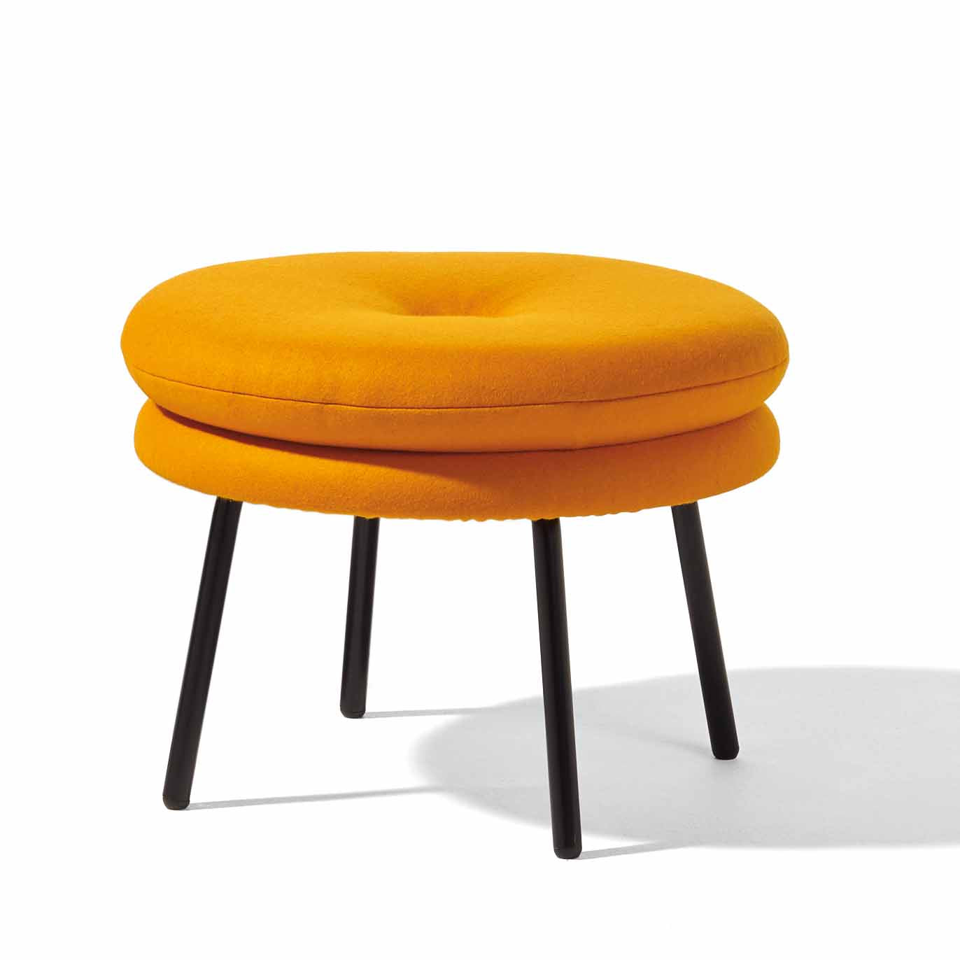 The Richard Lampert Little Tom Stool boasts a modern design with a round orange cushion, slightly indented on top, set against a white backdrop. Its sleek black metal legs add an elegant touch to any space.