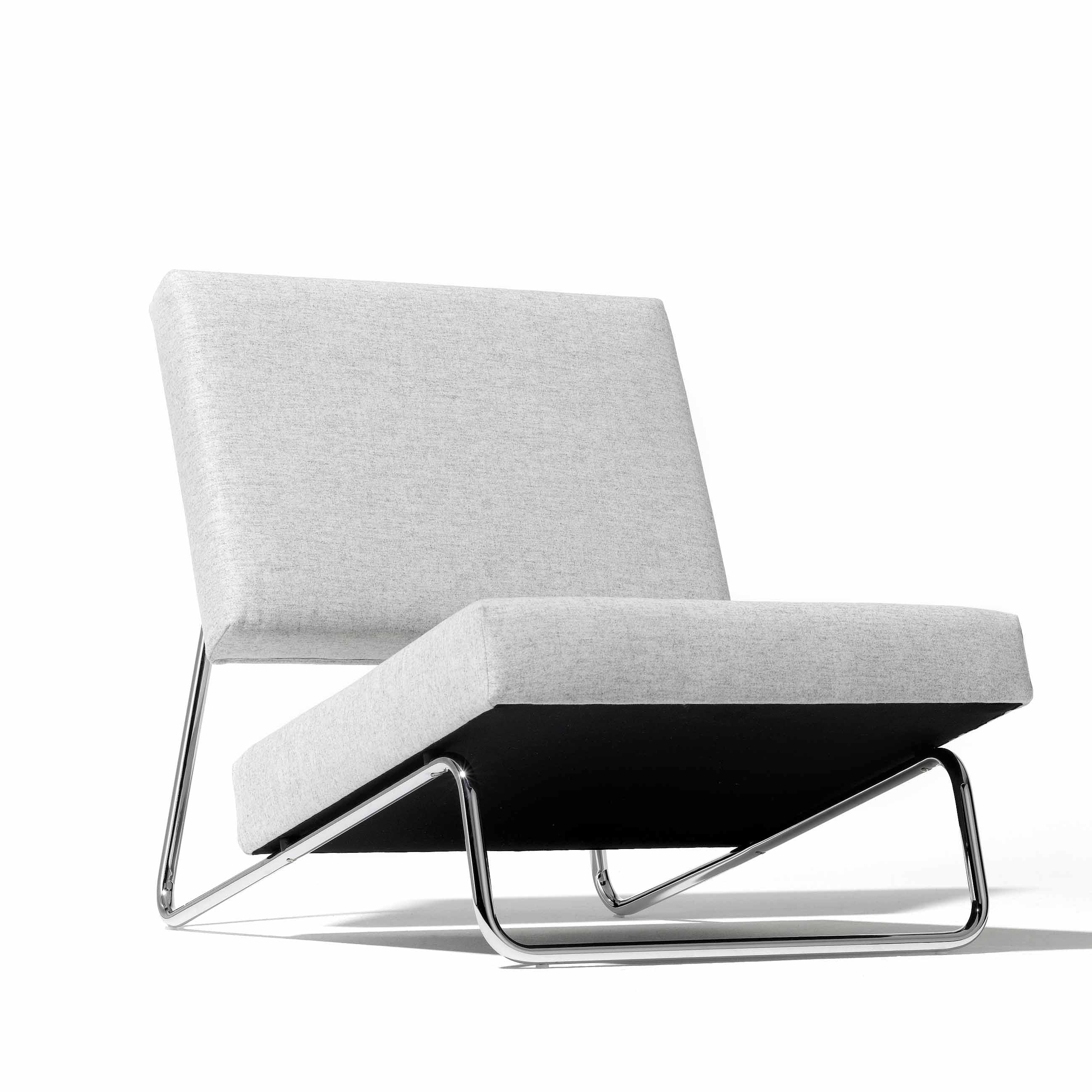 The Hirche Lounge Chair by Richard Lampert boasts a minimalist design with a light gray cushioned seat and backrest on an angled chrome frame, embodying Bauhaus principles to enhance any contemporary living area.