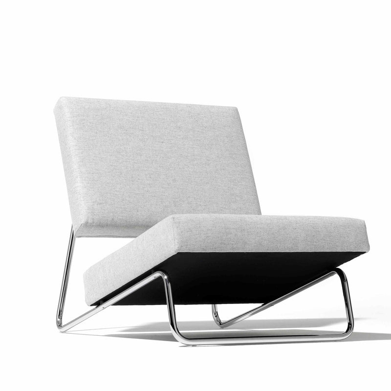 The Hirche Lounge Chair by Richard Lampert boasts a minimalist design with a light gray cushioned seat and backrest on an angled chrome frame, embodying Bauhaus principles to enhance any contemporary living area.