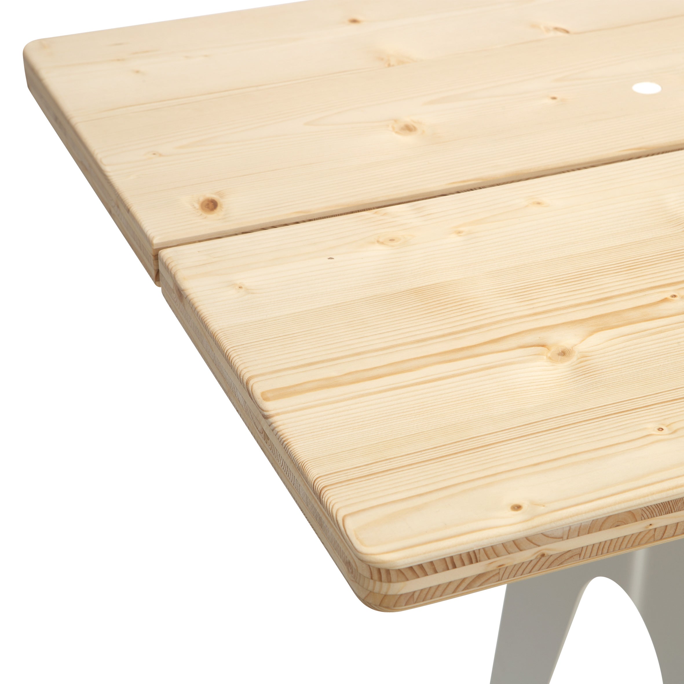 Close-up of the Ludwig Table by Richard Lampert, featuring a light wooden surface with a smooth, natural finish. Slightly rounded edges rest on weather-resistant white metal legs, while grain patterns add charm.