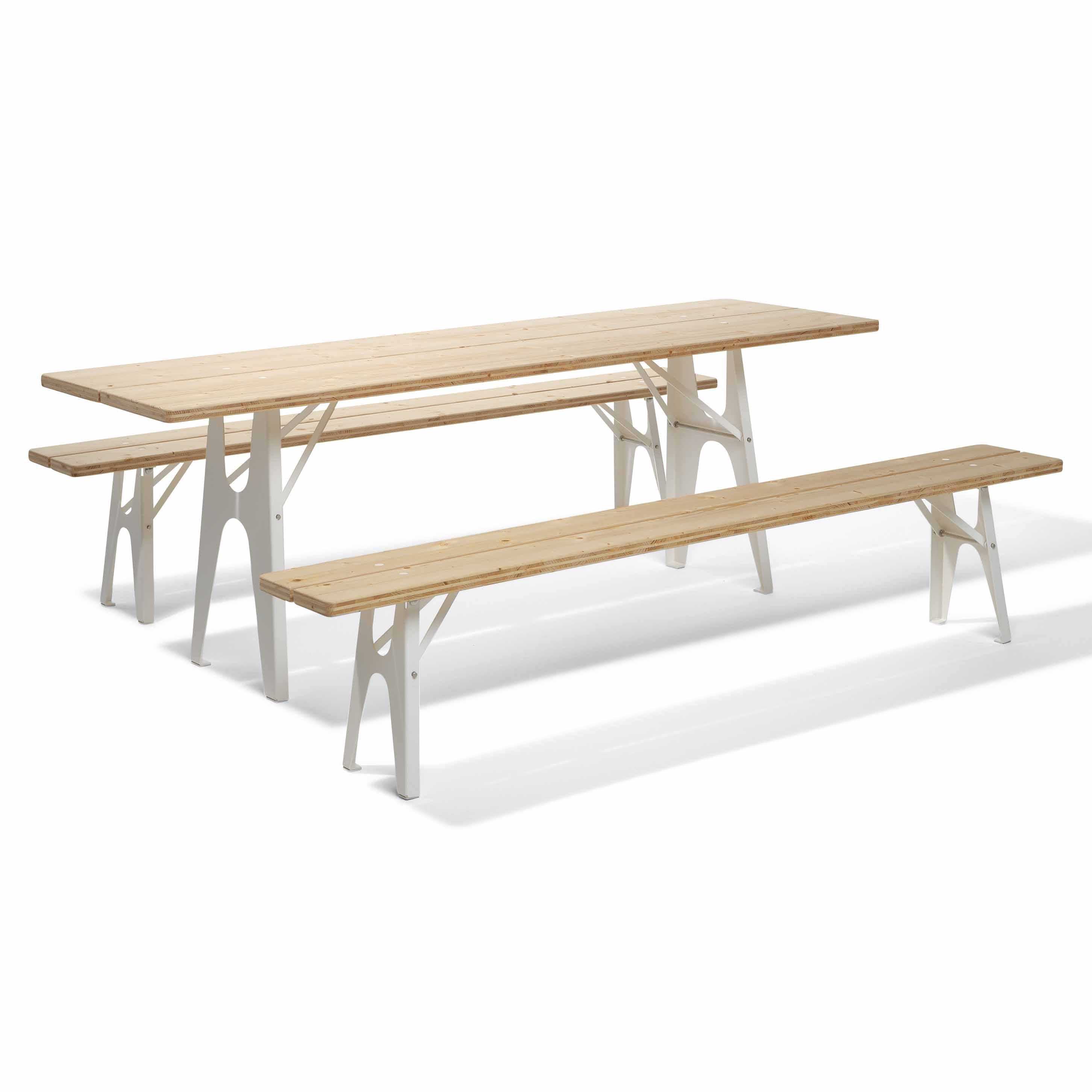 The Ludwig Table by Richard Lampert features a long wooden top with two benches and white, angular legs for a minimalist, modern look. Set against a white background, this durable piece is reminiscent of classic beer tables and fits seamlessly in any setting.