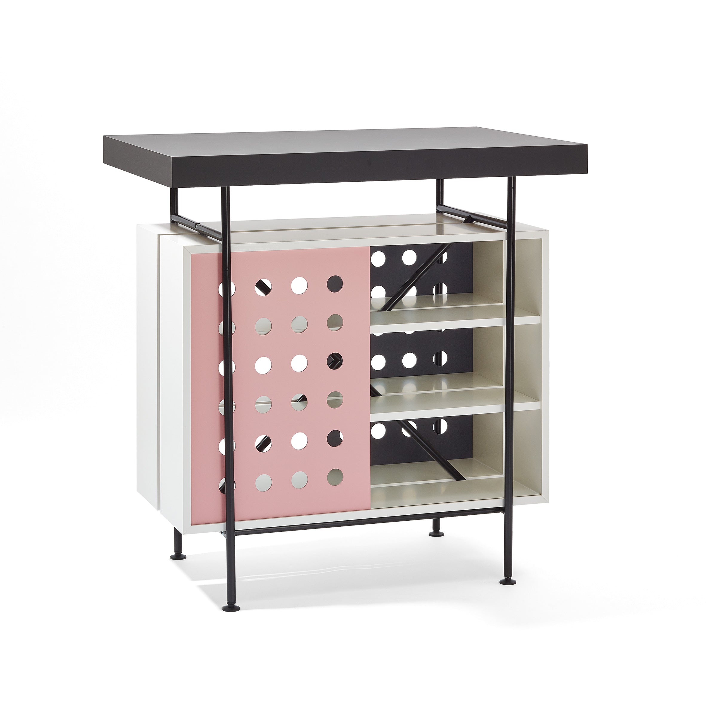 The Milla Bistro Table by Richard Lampert combines modern style and functionality with a black top, open shelves, a sliding door with a playful pink and white polka dot design, thin black metal legs, and mixed white and neutral shelving.