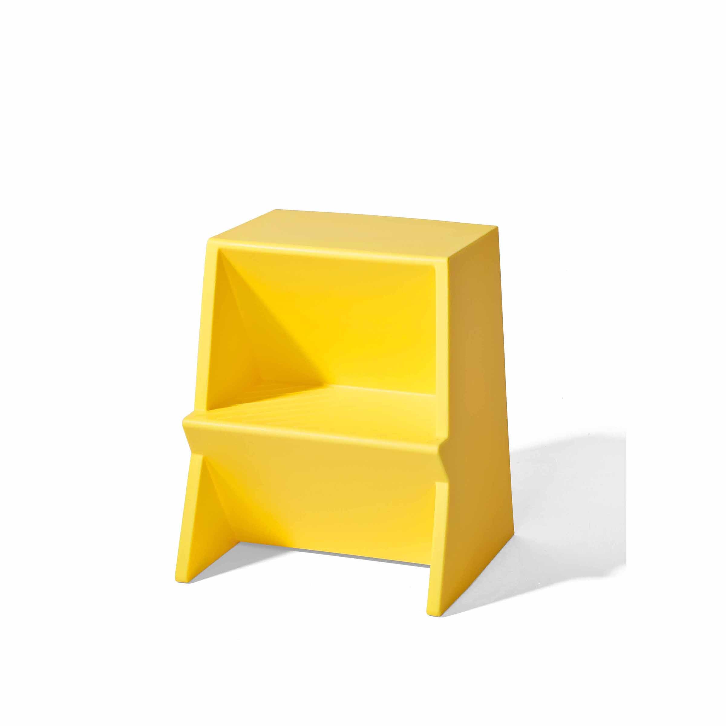 The Mono Stepstool by Richard Lampert is a modern, bright yellow, two-step stool made from recyclable polyethylene with a lightweight, minimalist, and angular design set against a plain white background.