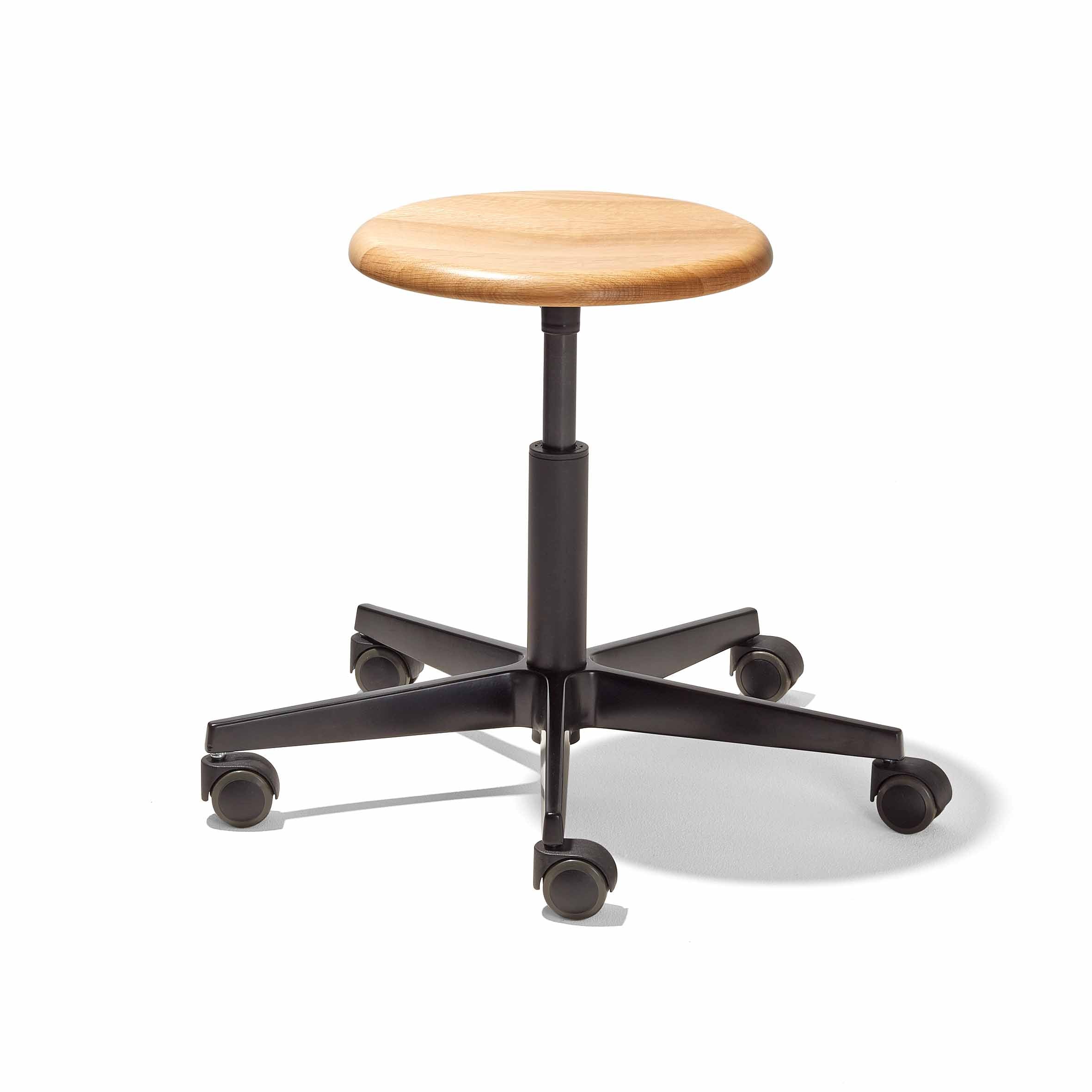 The Richard Lampert Mr. Round Swivel Stool is height-adjustable with a round wooden seat and black base featuring a gas spring system. Its five caster wheels enable easy movement, and the sleek design seamlessly blends natural wood with industrial elements for space-saving efficiency.