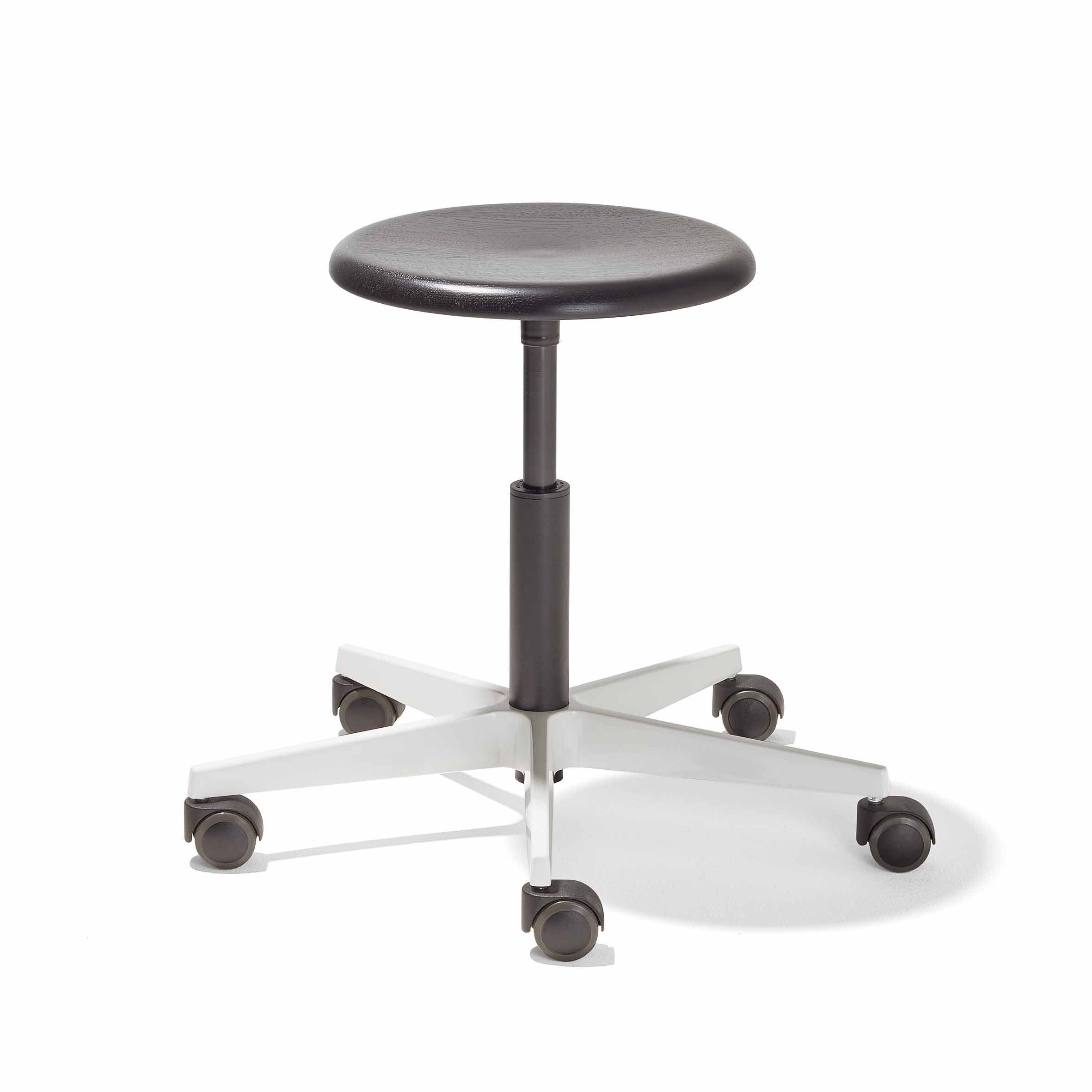The Richard Lampert Mr. Round Swivel Stool features a black round seat with height adjustment via a gas spring system on a five-star white base, equipped with black rolling casters for mobility, offering an ideal space-saving solution.