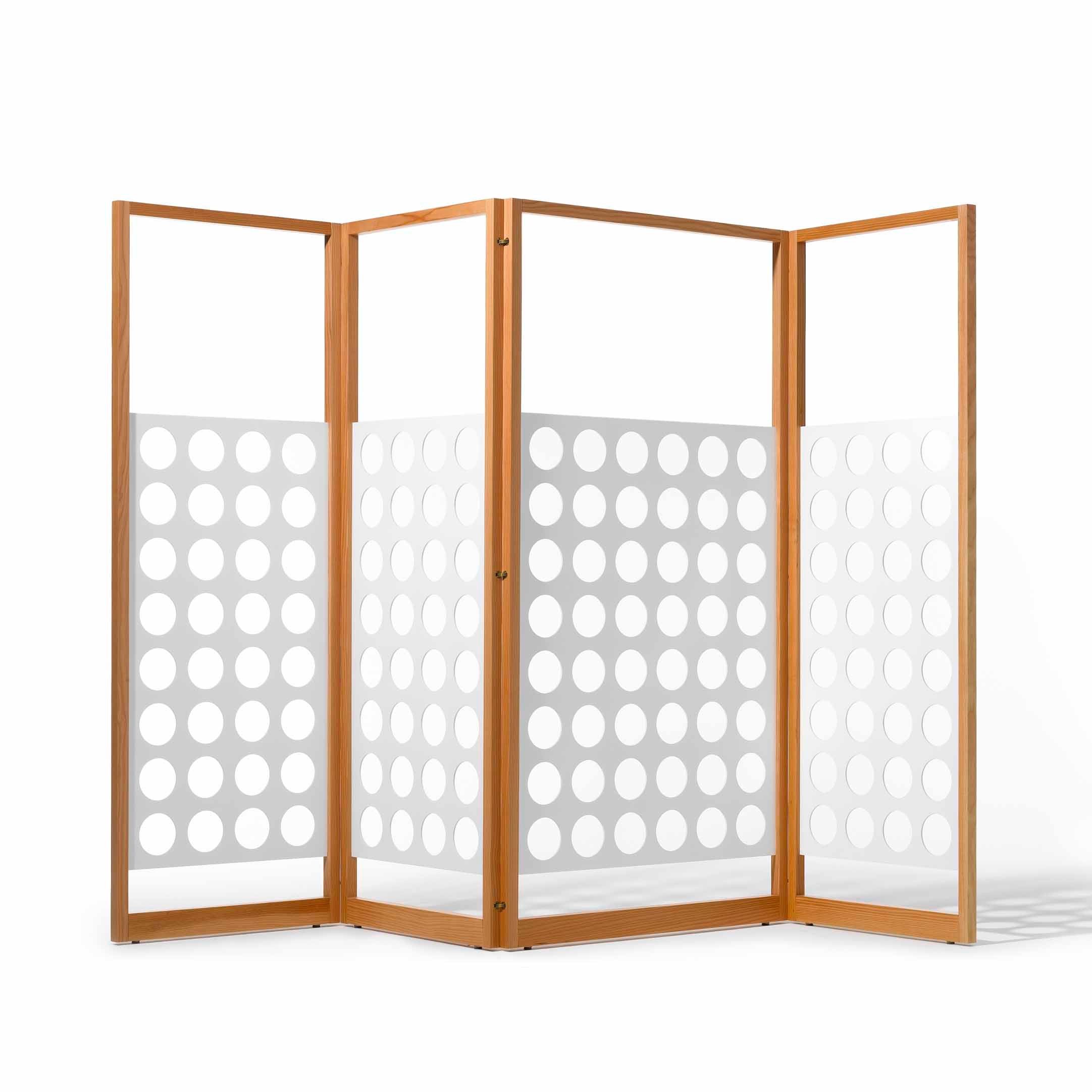 The Eiermann Screen by Richard Lampert is a four-panel wooden room divider with white sections and uniform circular cutouts, offering a modern Bauhaus-inspired geometric design that balances privacy and openness.