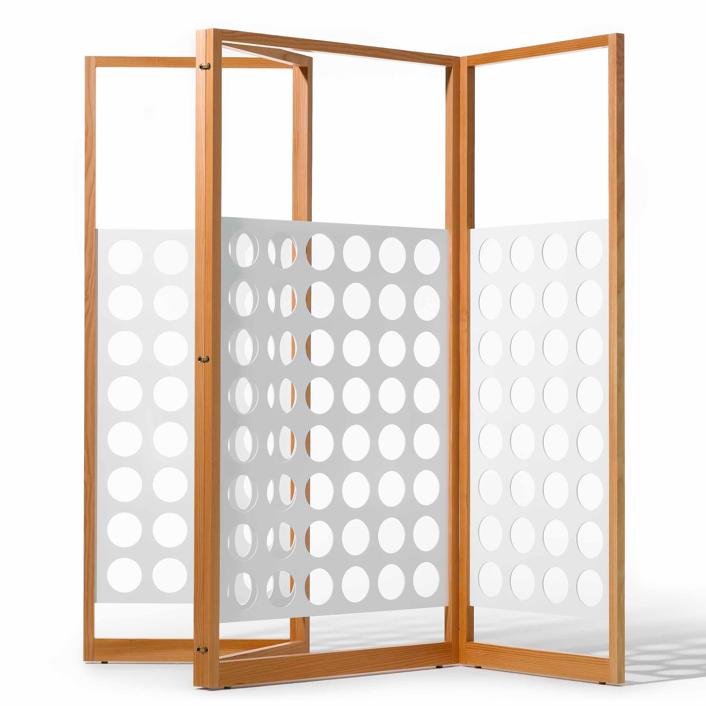 The Eiermann Screen by Richard Lampert is a wooden, three-panel folding screen ideal as a room divider. It features white sections with circular cutouts, merging classic and modern minimalist design with Bauhaus-like geometric flair.