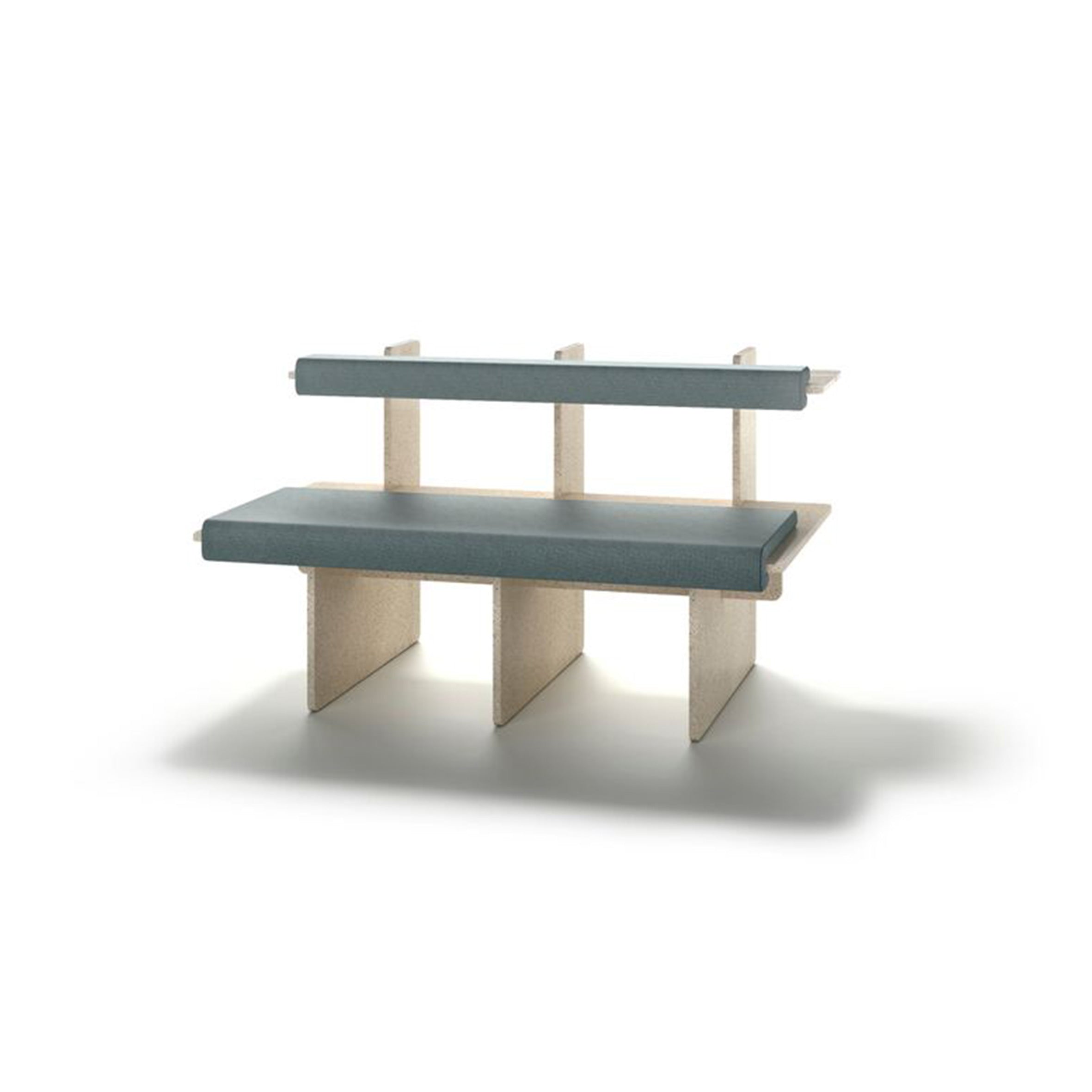 The Pip bench by Richard Lampert features a wooden frame with a light blue cushioned seat and backrest. Its modern, minimalist design offers customizable seating with clean lines and a geometric shape, perfectly contrasting against the white background.