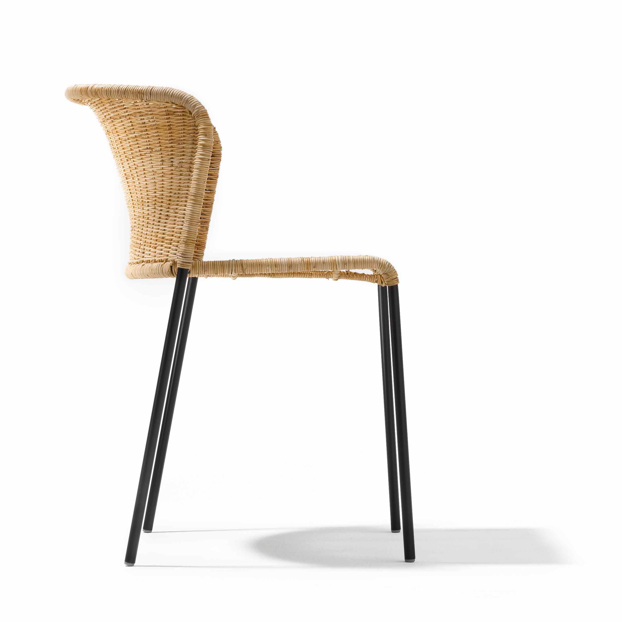 Side view of the Santa Lucia chair by Richard Lampert, showcasing a wicker seat and backrest with sleek black metal legs, set against a white background.