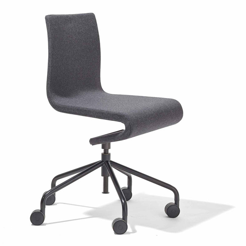 The Seesaw Task Chair by Richard Lampert is a modern, dark gray armless ergonomic office chair. It has a curved backrest and seat with a black adjustable swivel base on five caster wheels, offering subtle rocking motion, set against a plain white background.
