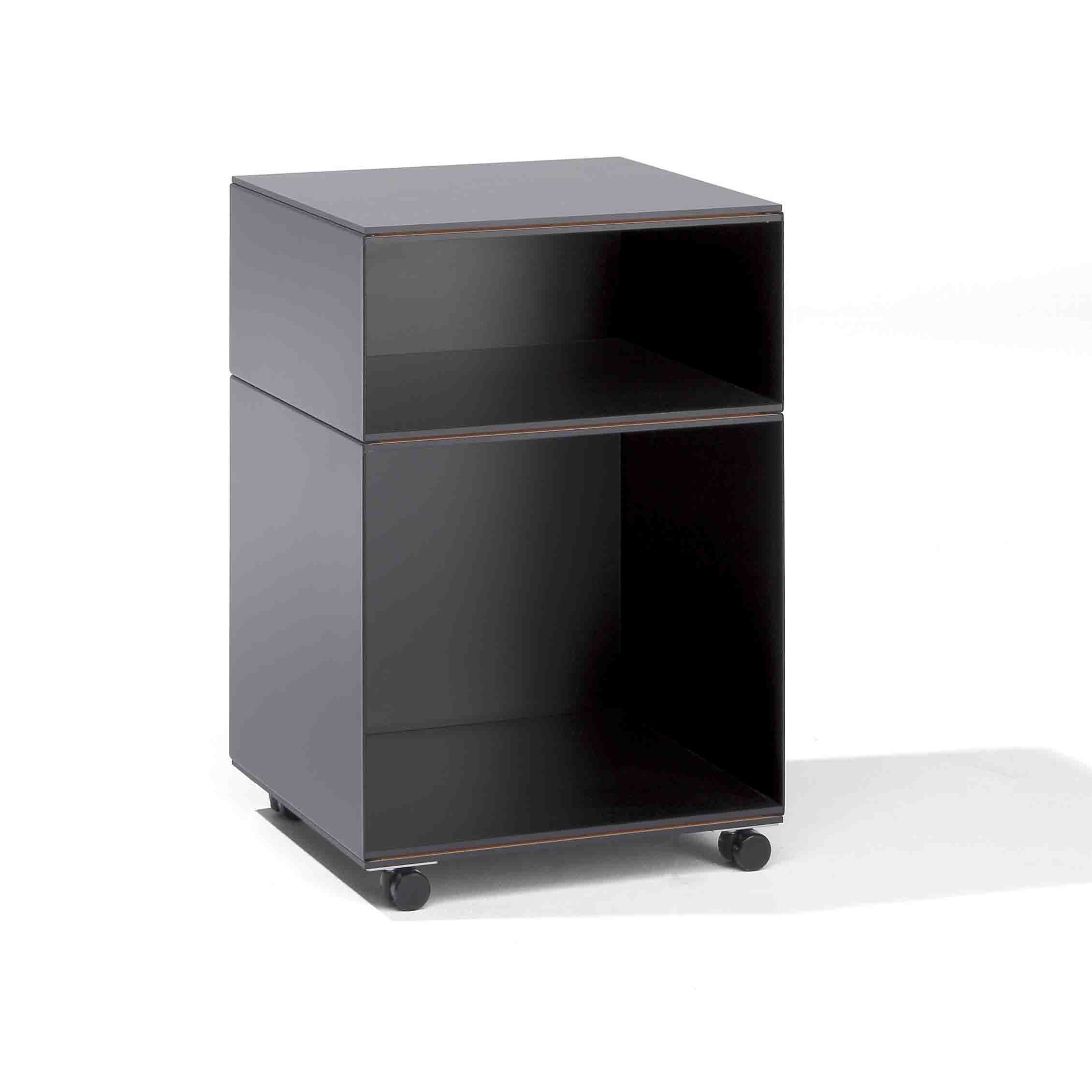 The Stak Trolley System by Richard Lampert is a modern, minimalist shelving unit with solid oak shelves and adjustable castors. Featuring two open shelves, it offers sleek design flexibility against a plain white backdrop, ideal for innovative storage or display.