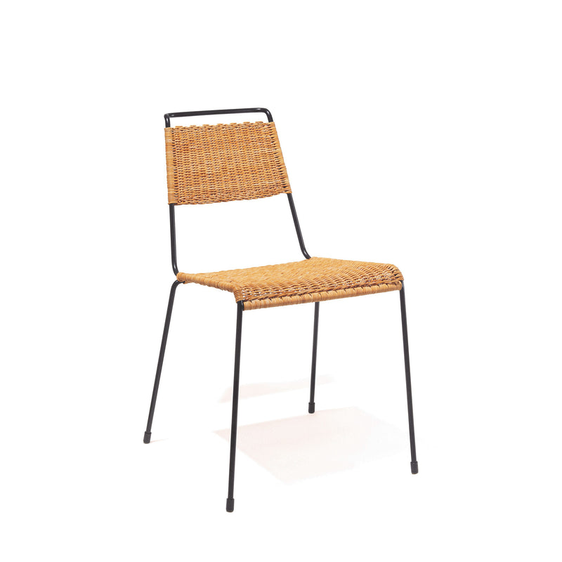 The Richard Lampert TT54 Rattan chair boasts a woven rattan-style backrest and seat, ergonomic design, minimalist black metal frame, and four slender steel rod legs for a sleek look on a plain white background.