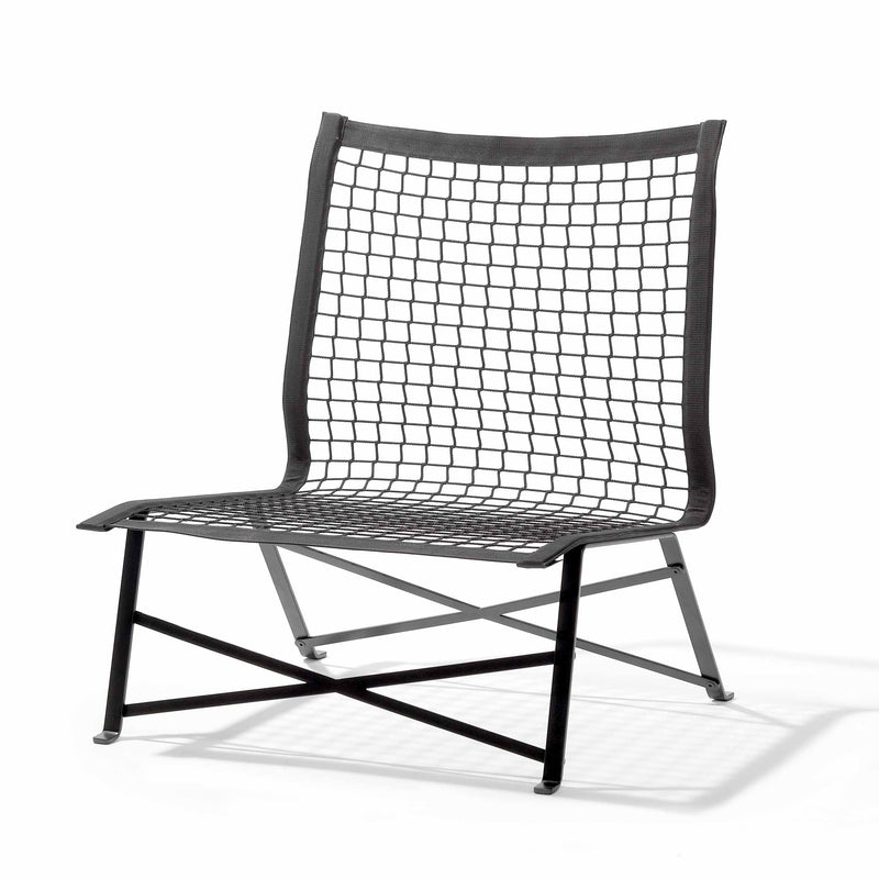 The Tie-Break Lounge Chair by Richard Lampert boasts a minimalist design with a black flat-rolled steel frame, netted backrest and seat, and crossed metal supports at the base—perfect for stylish garden or outdoor armchair settings.