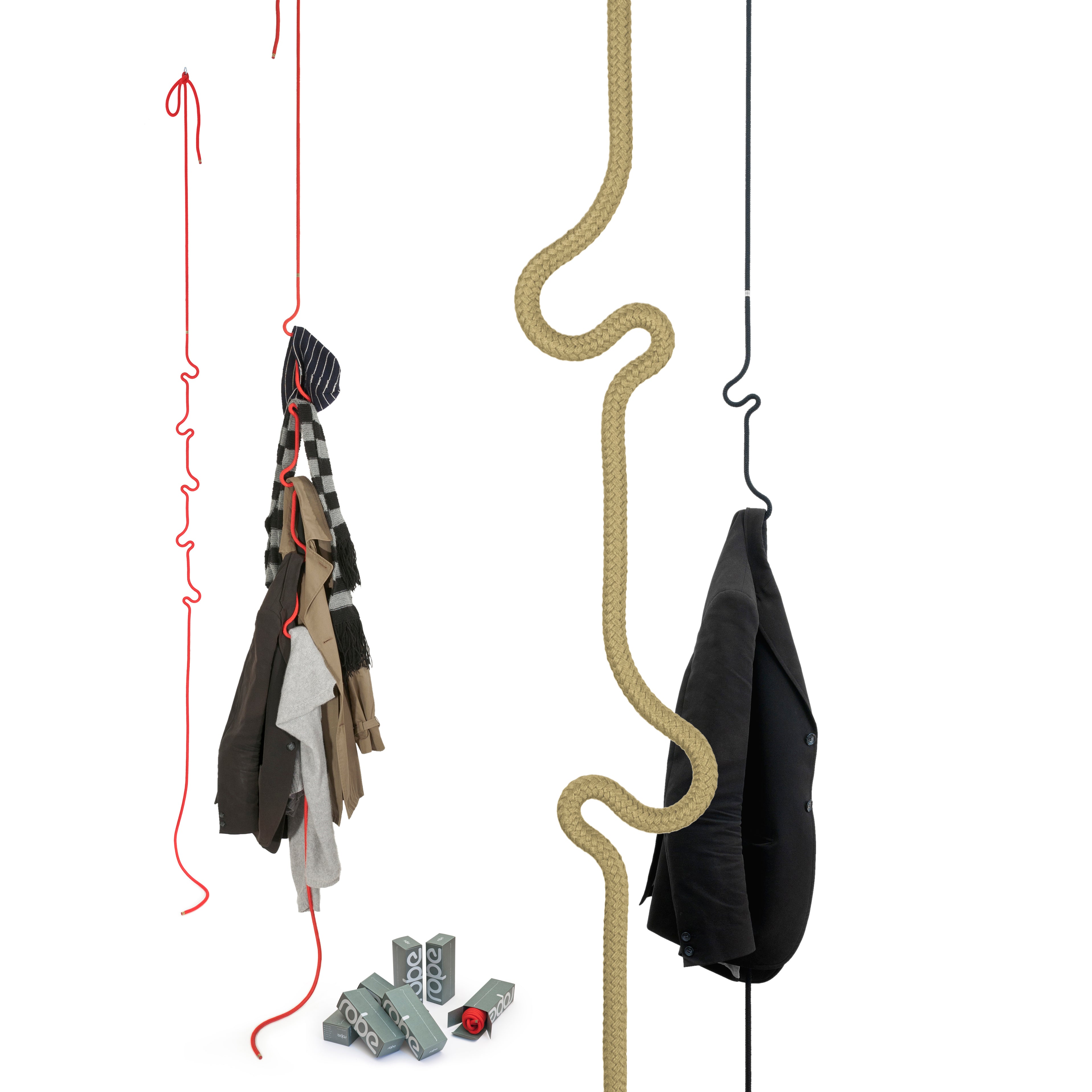 The colorful, curvy Roberope hooks from the ceiling display clothing items. Adjustable for flexibility, a red one holds multiple garments and a black one cradles a single jacket. Numbered blocks with wheels sit on the floor next to a zigzag polyester yarn rope by Roberope.