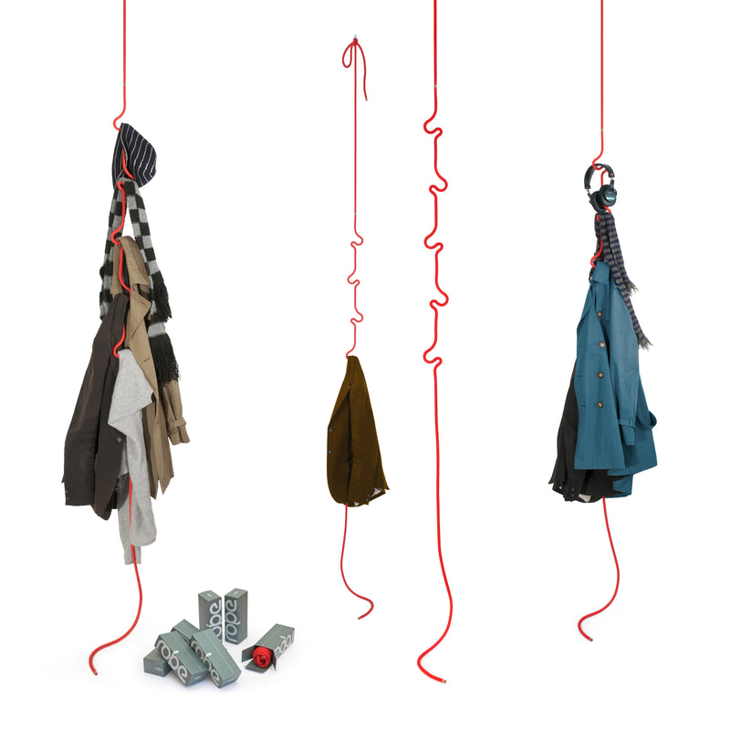 Three Roberope hangers in red wavy design hold jackets, scarves, and headphones with style and durability thanks to their polyester yarn construction. Below them, gray and red Roberope mats are perfectly stacked.