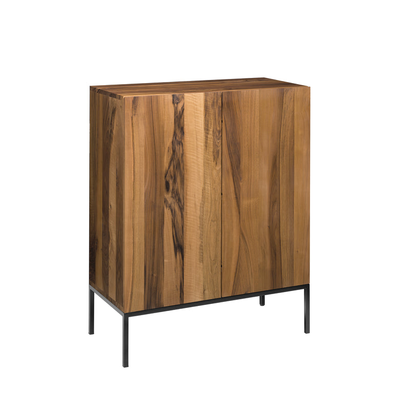 The E15 SB03 FARIBA is a minimalistic, modern wooden cabinet crafted from solid wood with a natural finish and vertical grain patterns. It features automatic-closing double doors and is elevated on black metal legs, set against a plain white background.
