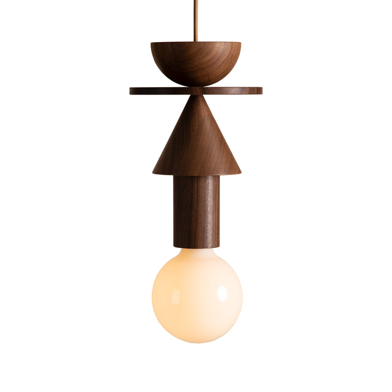 The Junit Stanza by Schneid captures Bauhaus aesthetics with a geometric wooden design, layering a half-sphere, cone, and cylinder in rich walnut. It hangs elegantly from a cord and features a round frosted bulb that emits a warm glow.