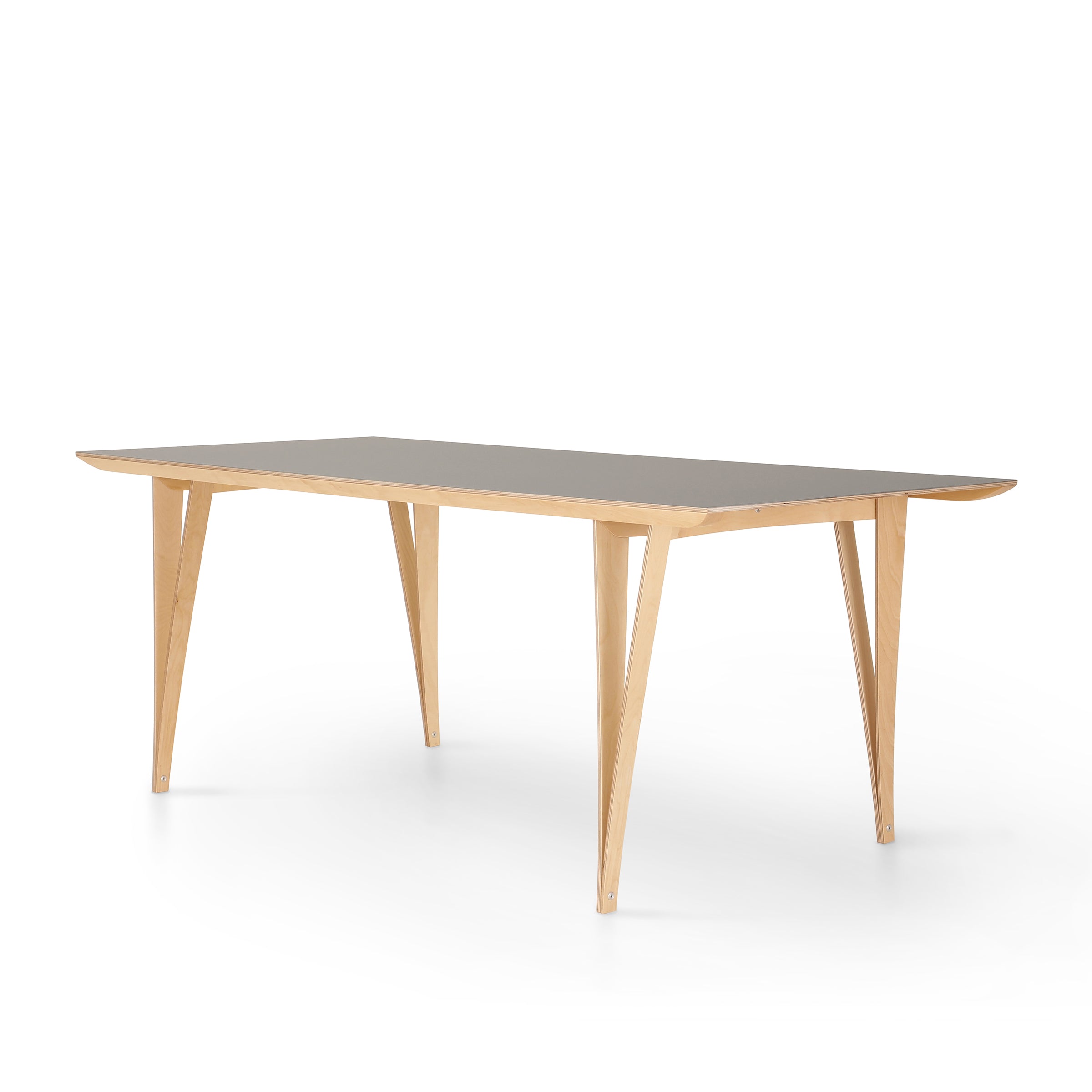 The Spanoto by Moormann is a sleek wooden dining table with a rectangular black birch plywood tabletop, standing on four angled light wooden legs, set against a plain white background.