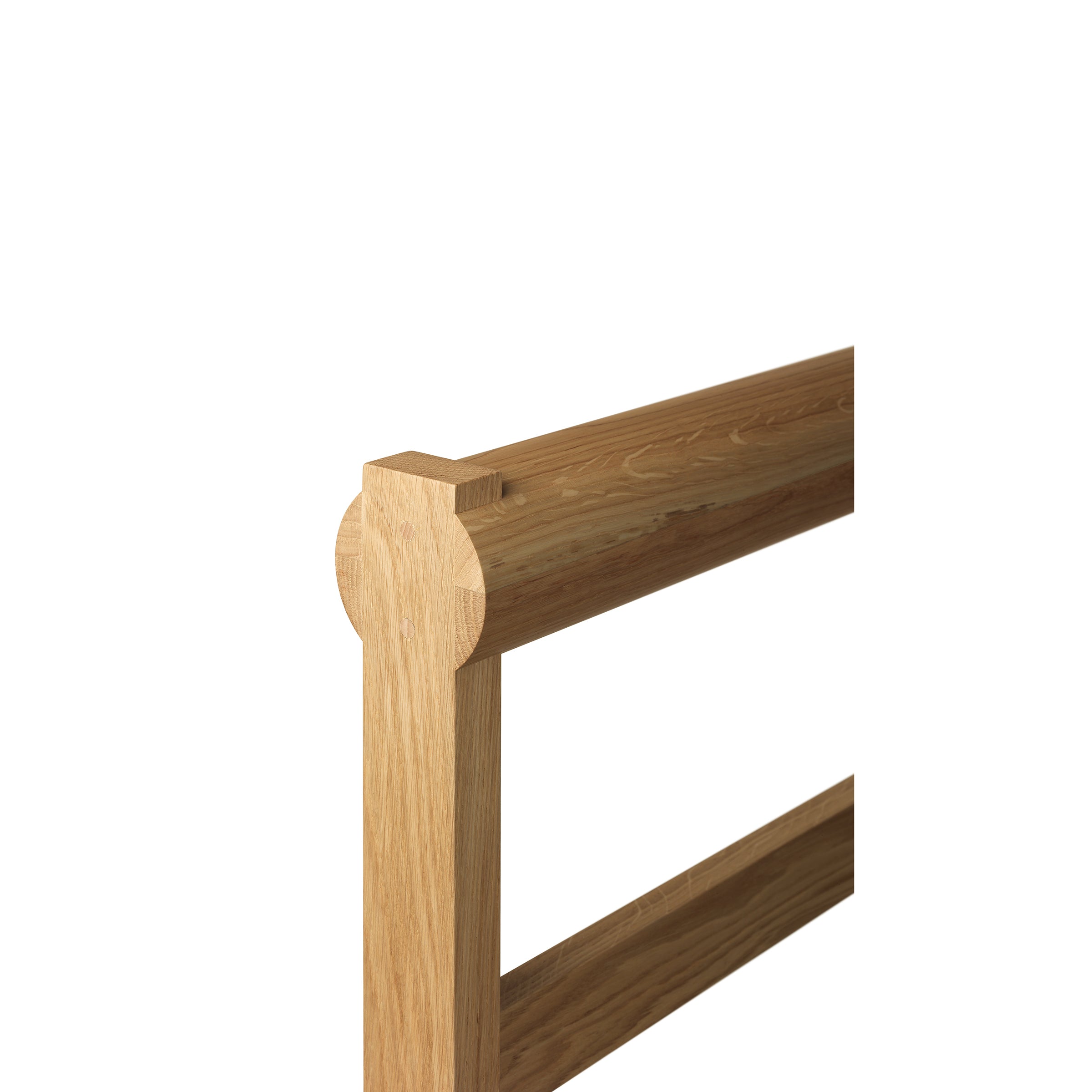 Close-up of a wooden corner from the E15 SX03 GAMAR Wardrobe Stand with a simple, light European oak design showcasing smooth edges and visible wood grain. The photo highlights the headboard and side rail connection.