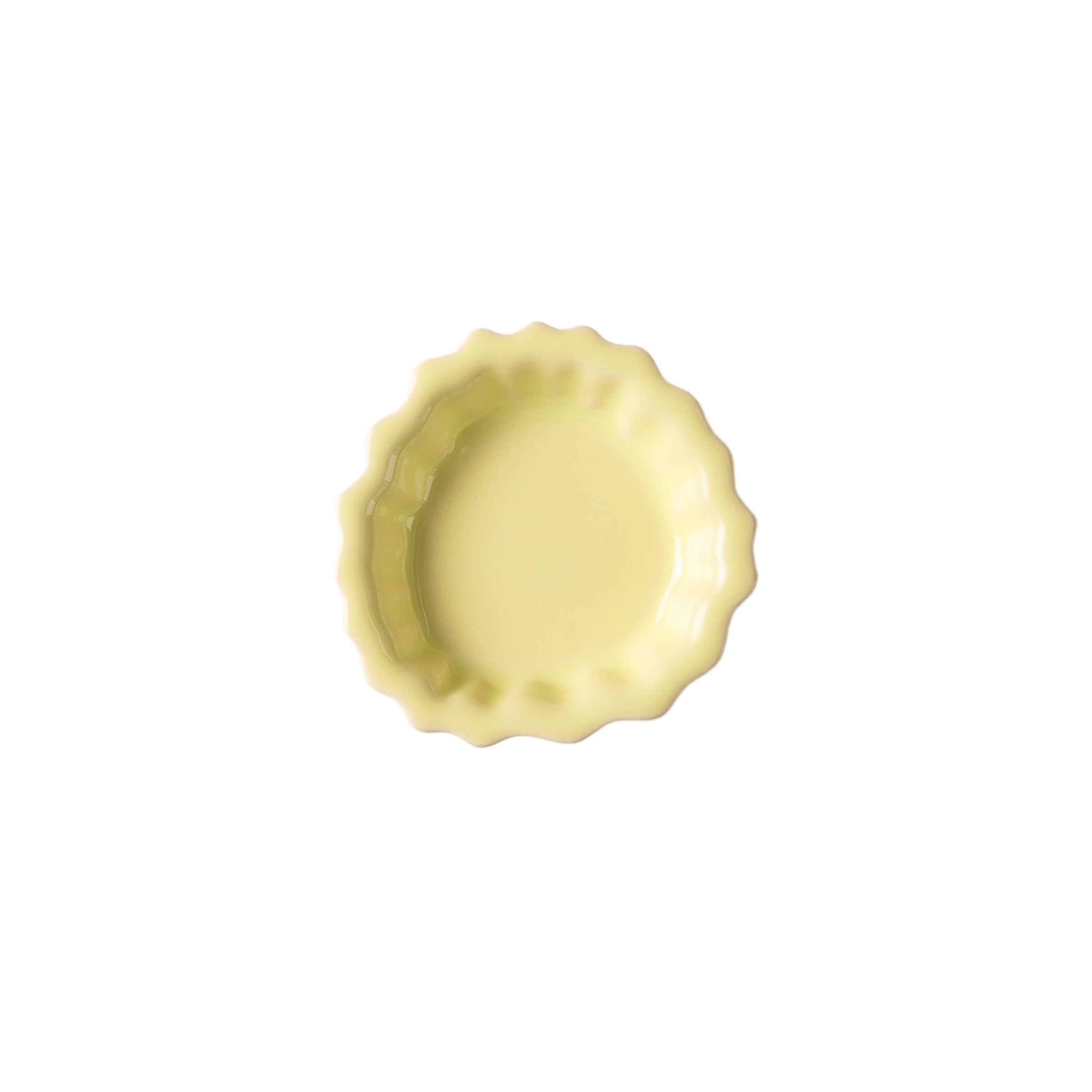 A yellow round Fossil Hooks dish by Schneid, viewed from above on a white background, highlights its colorful glazes.