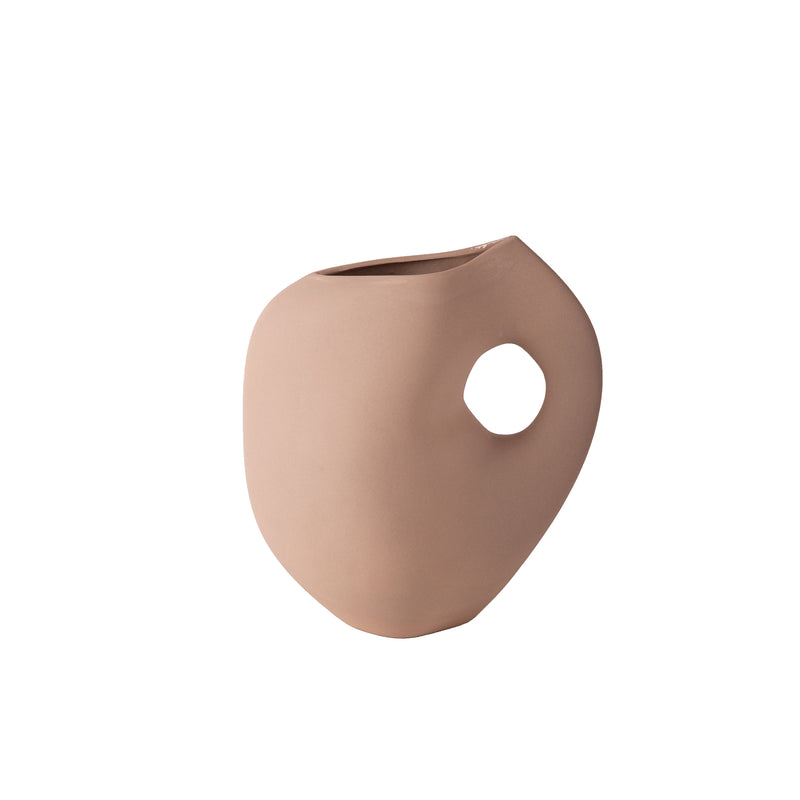 The Aura I vase by Schneid is a beige, matte, unglazed ceramic piece with a smooth, rounded, asymmetrical design. It features a wide opening and distinctive circular cutout for an artistic touch.