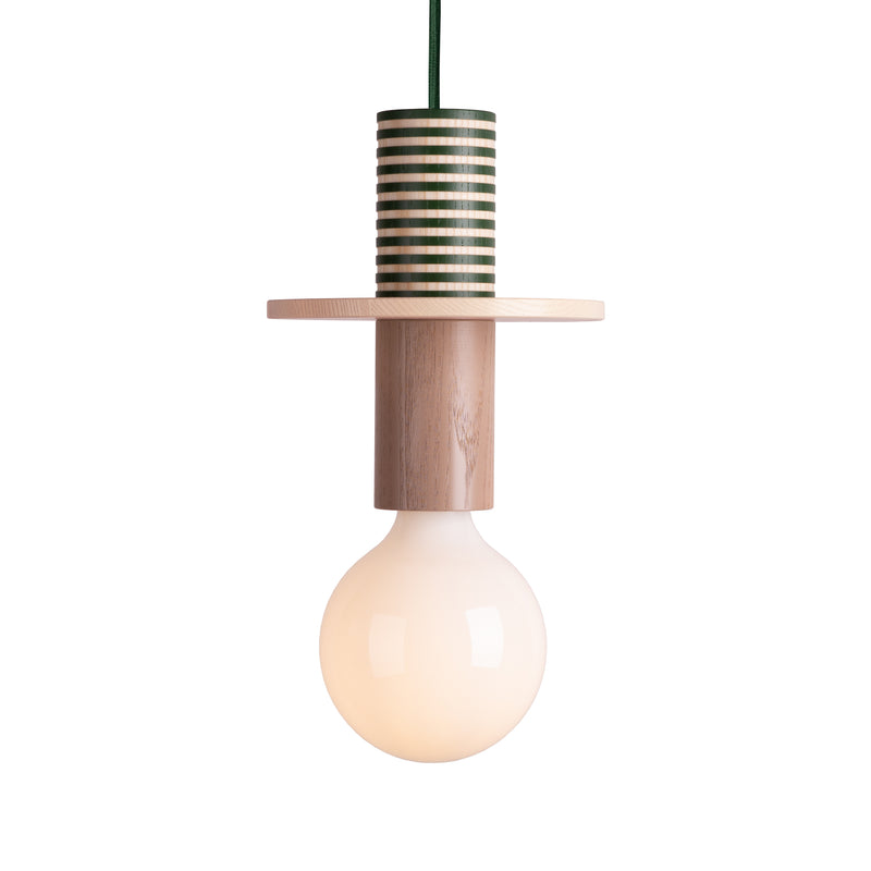 The Junit Tame by Schneid is a modular pendant lamp featuring a minimalist design with a round, white bulb. It has an ambient light with a wooden socket holder showcasing a striped green and white top and plain ash wood below, complemented by a gracefully hanging green cord.