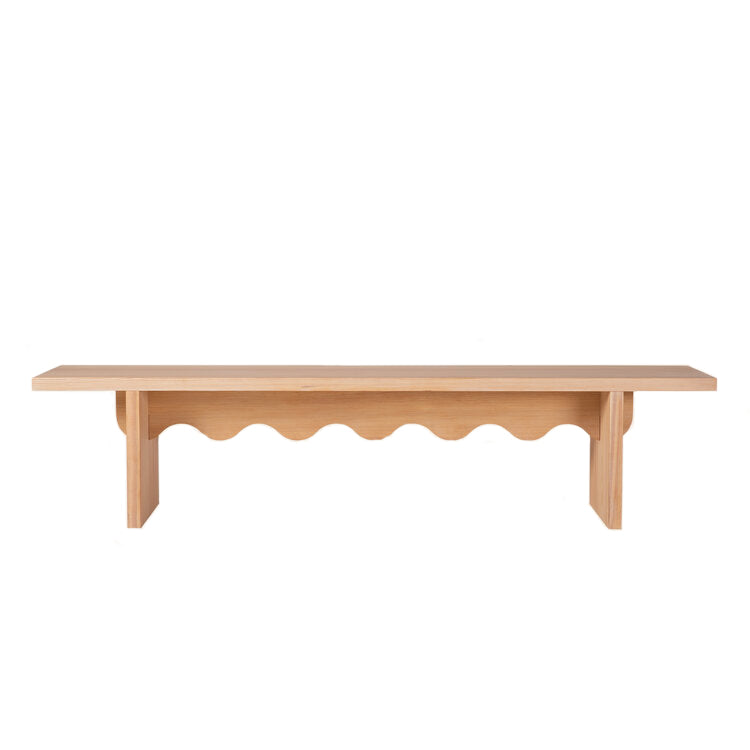 The Tami Bench by Schneid, part of the Tami Dining Collection, features a flat top with a unique wavy cut-out below. Made from light-finished larch wood for a natural and modern aesthetic, its ideal for both indoor and outdoor use.